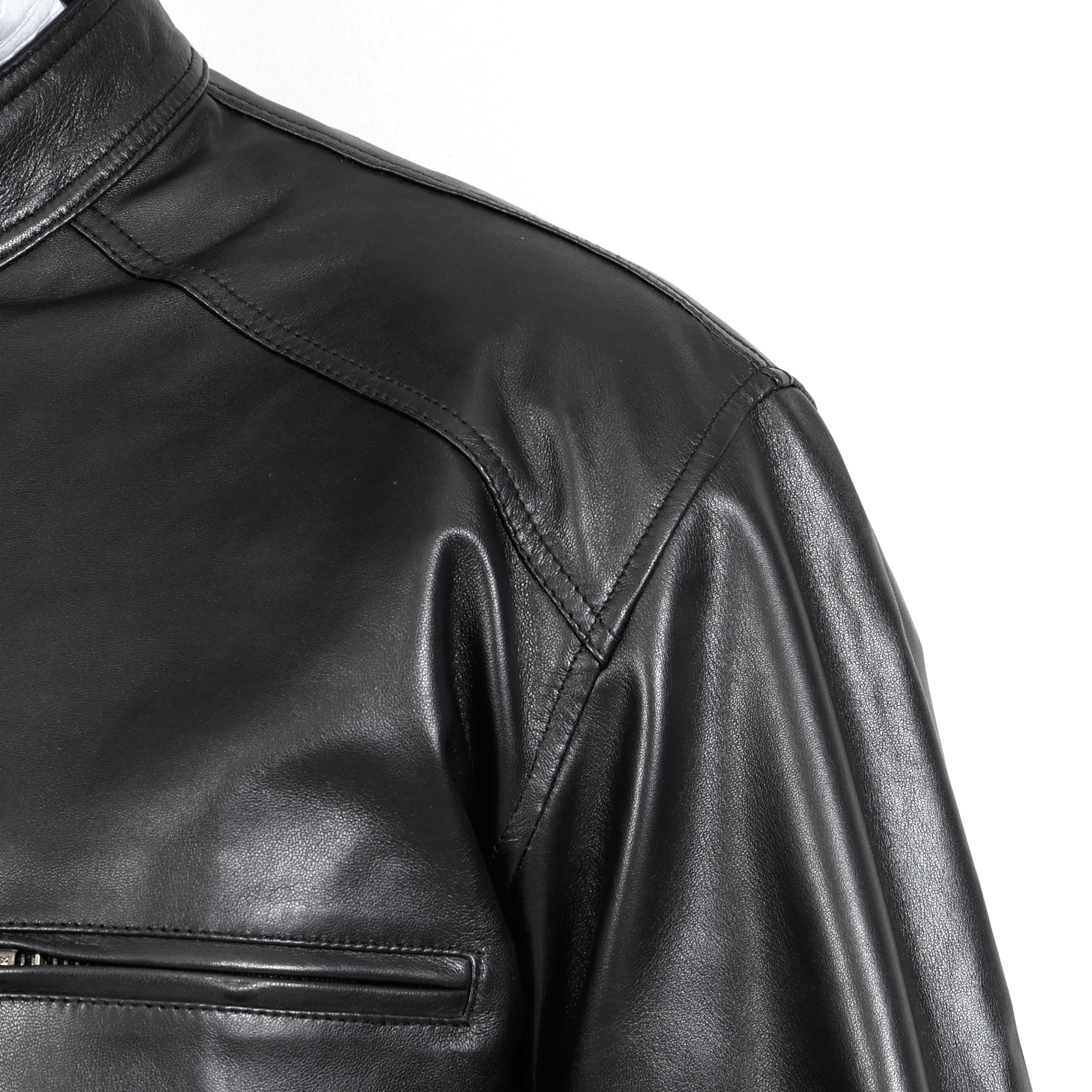 Close-up of a black leather jacket on a white background