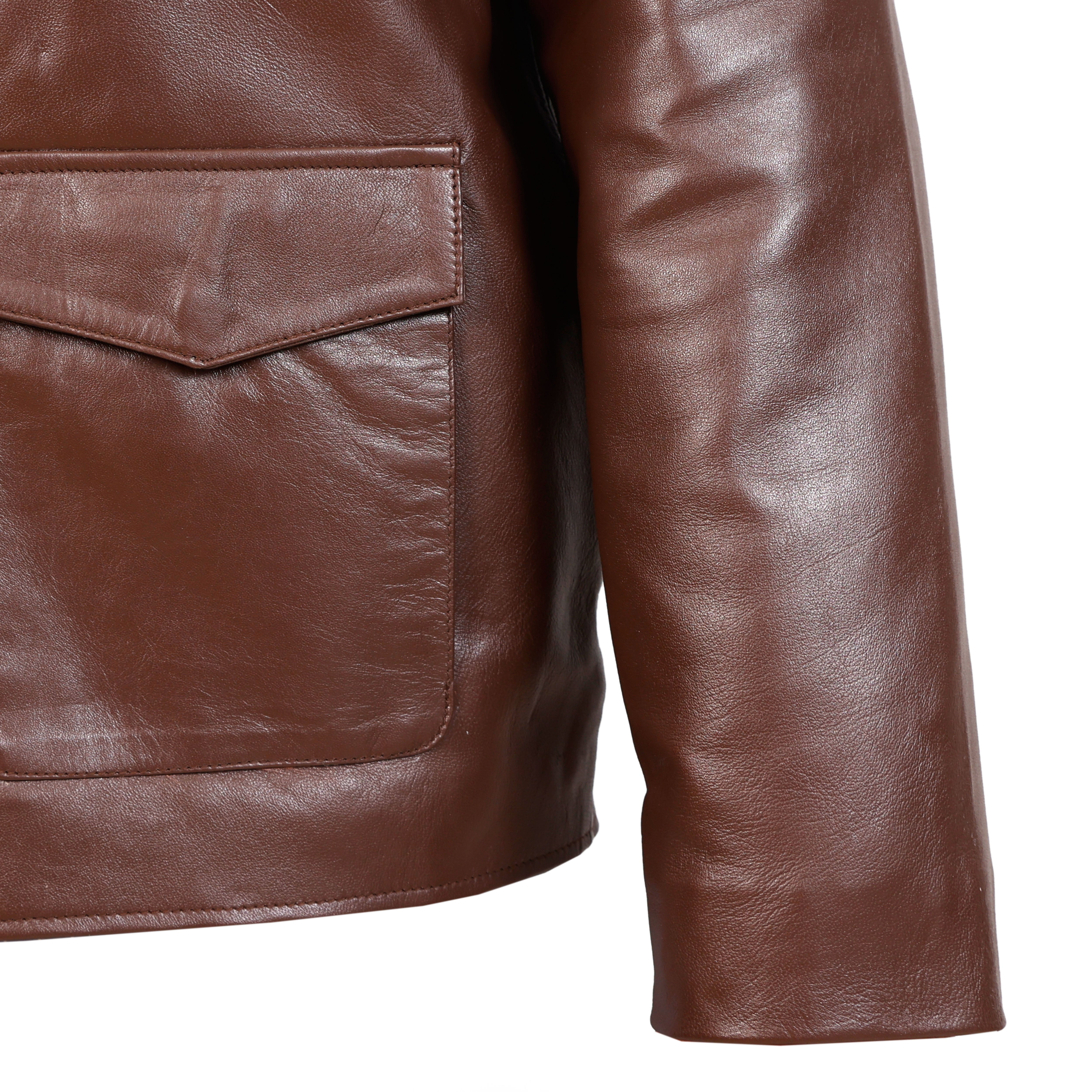 Close-up of a brown leather jacket with a pocket on a white background