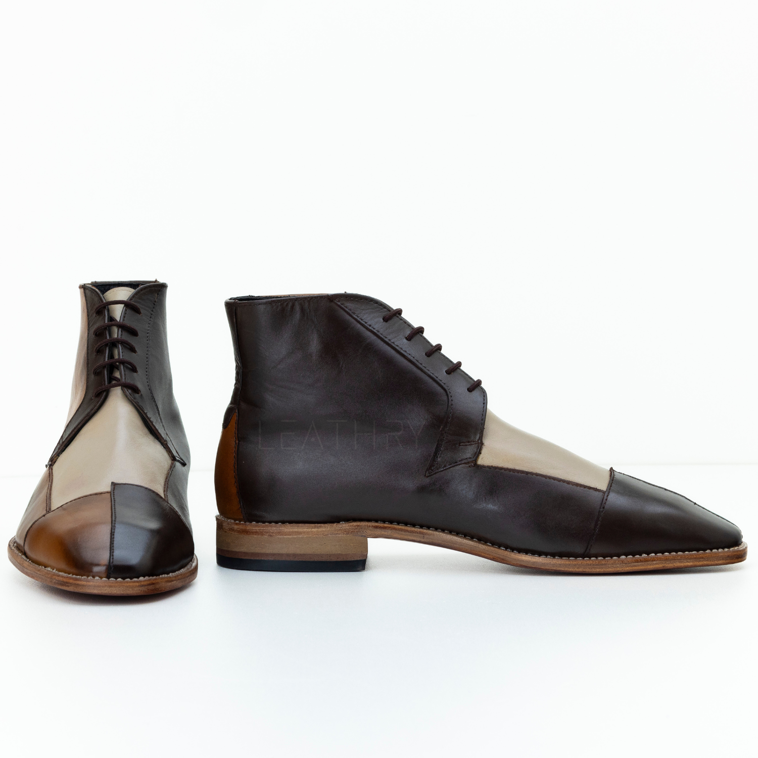 Pair of black and beige leather shoes on a white background