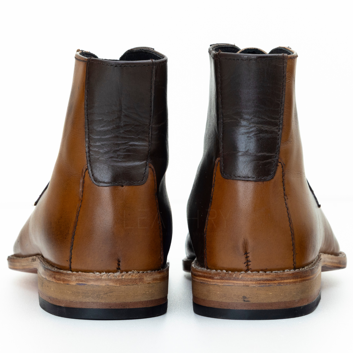 Pair of brown leather boots on a white background