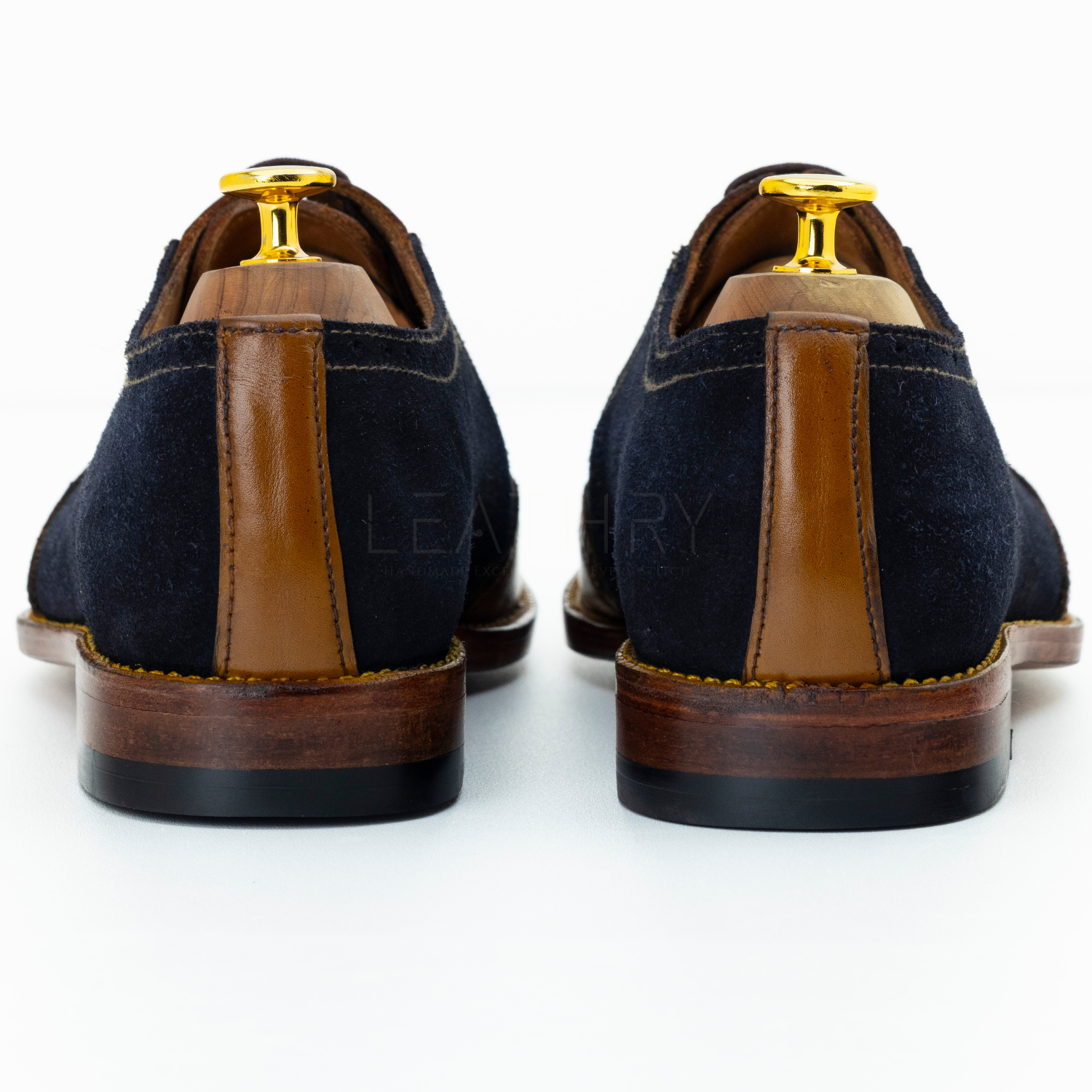 Brown leather dress shoe on a gray background