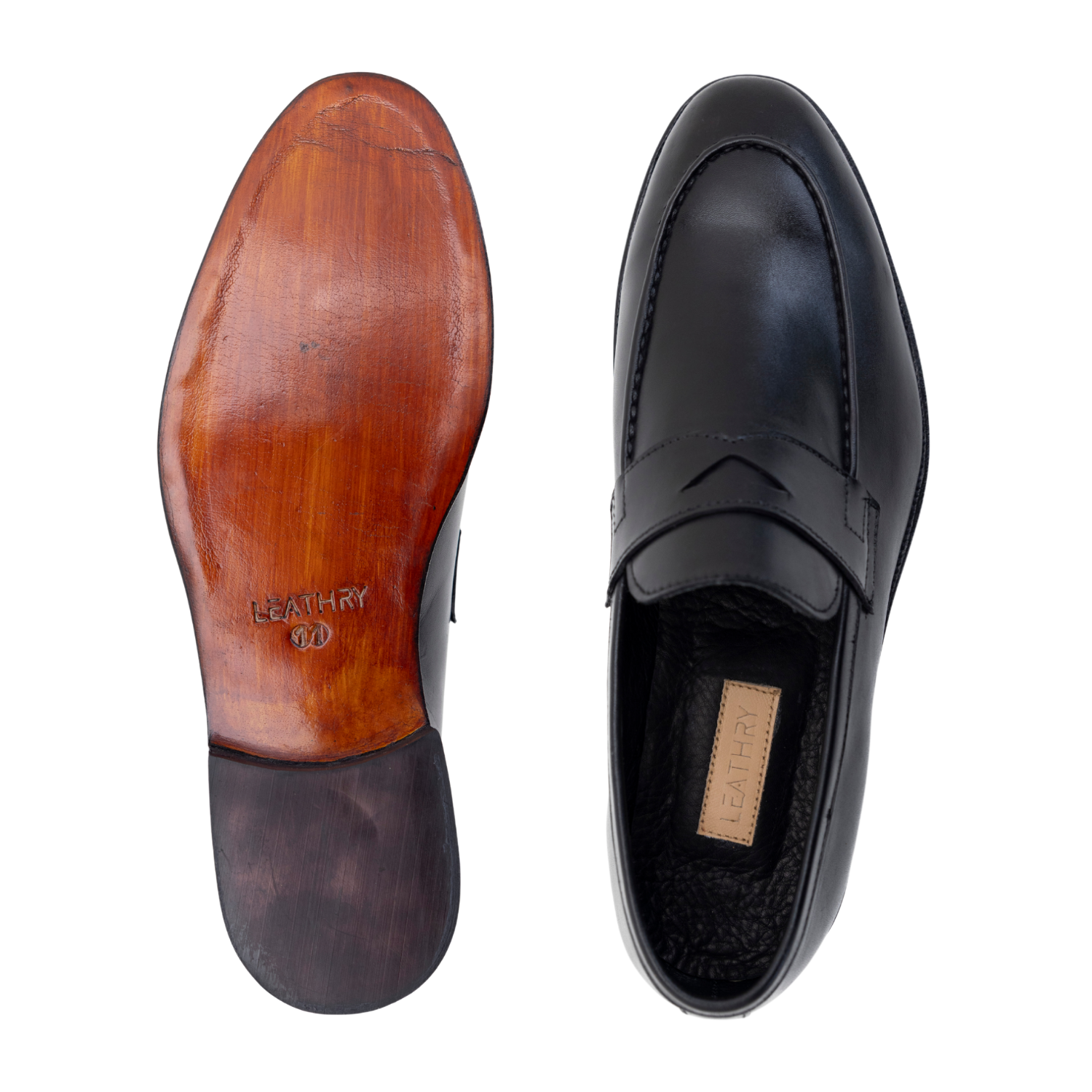 Black leather loafer shoe with wooden sole on a white background