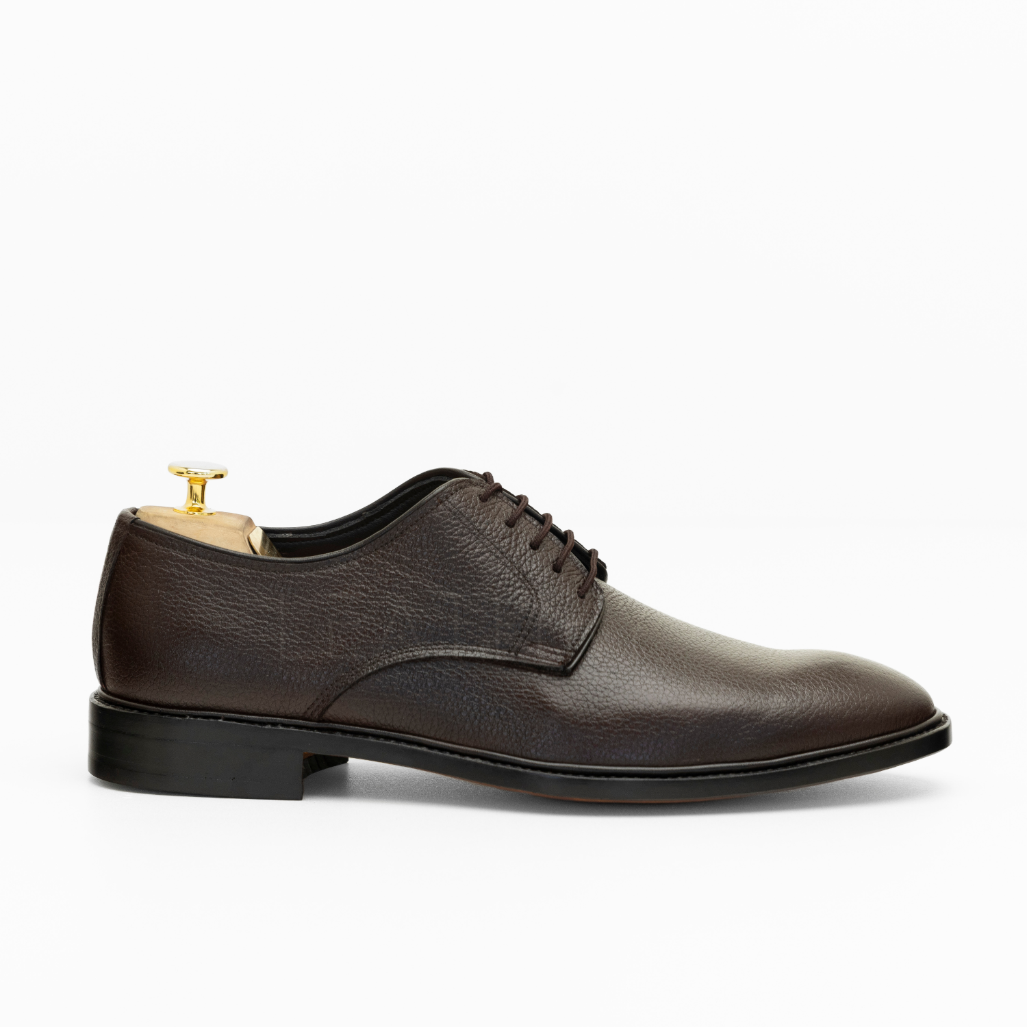 Brown leather dress shoe on a white background