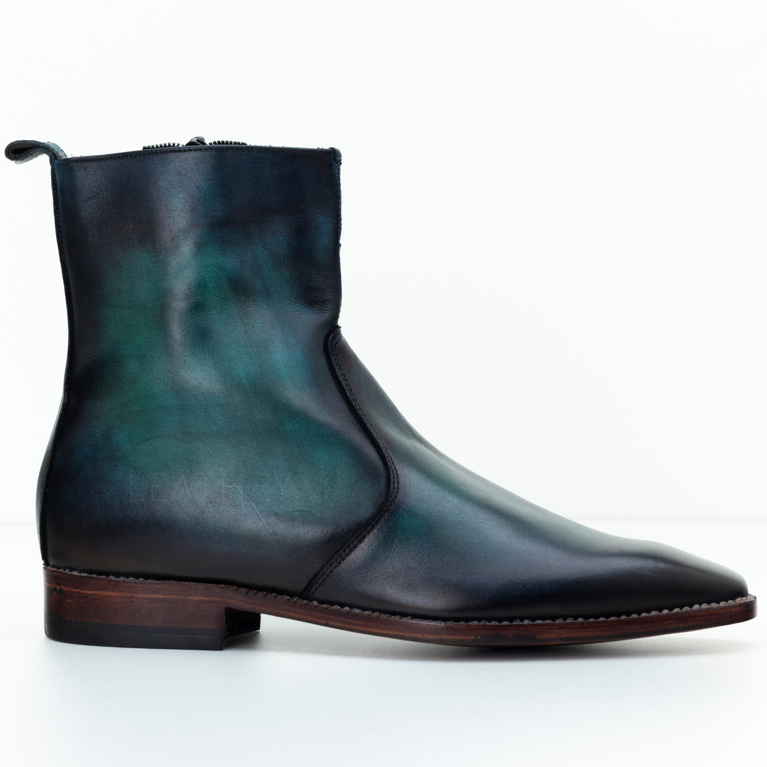 Green leather boot on a white background