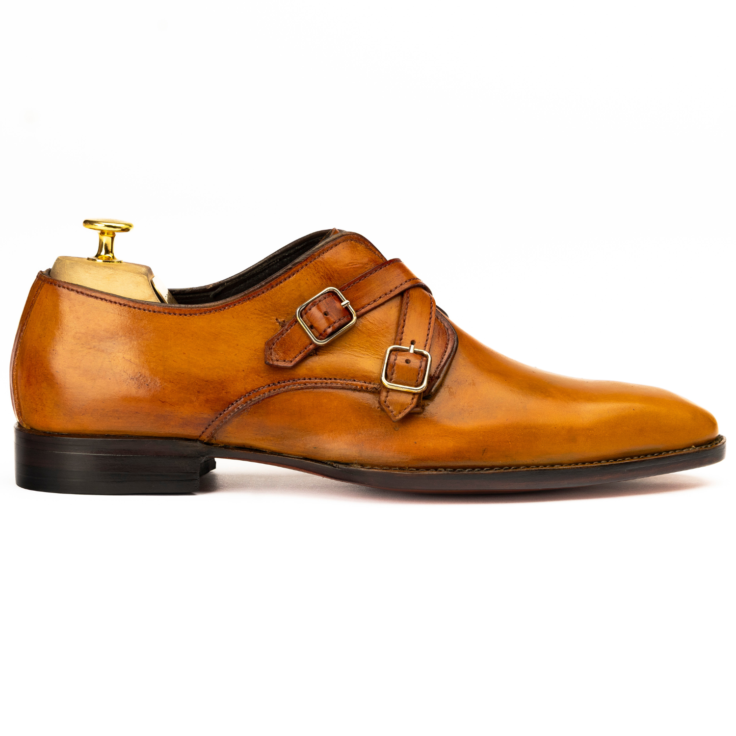 Brown leather dress shoe with a strap on a white background