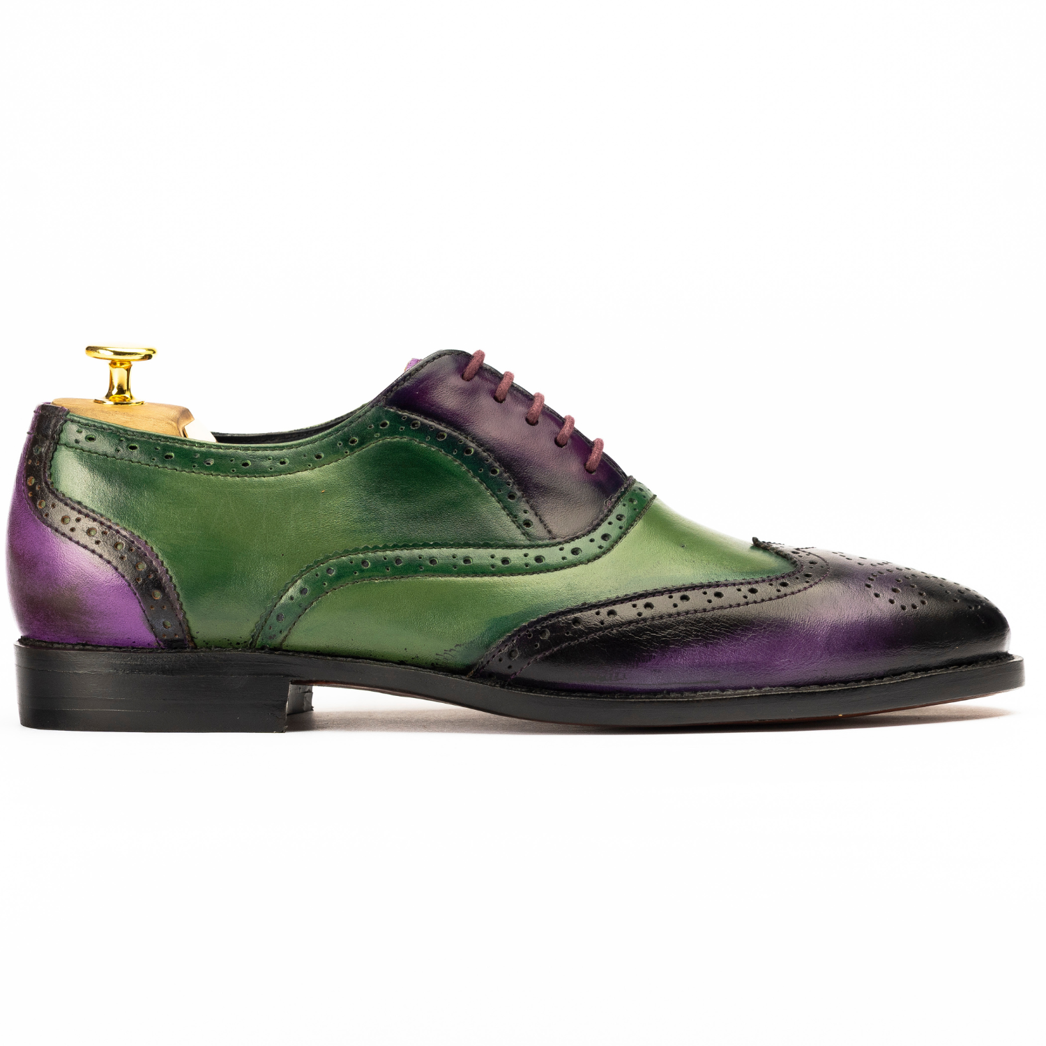 Green and purple leather shoe on a white background
