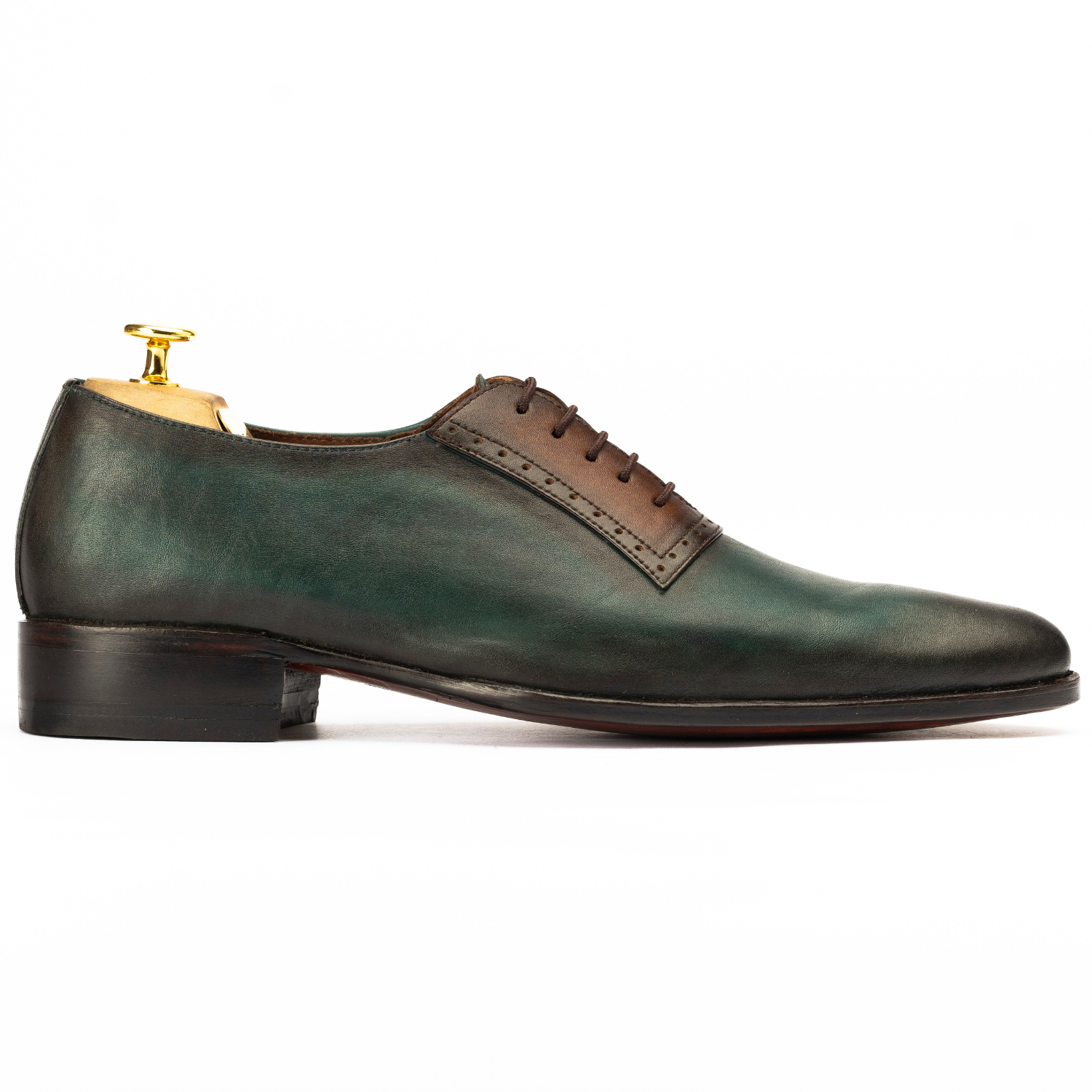 Green leather dress shoe with brown accents on a white background