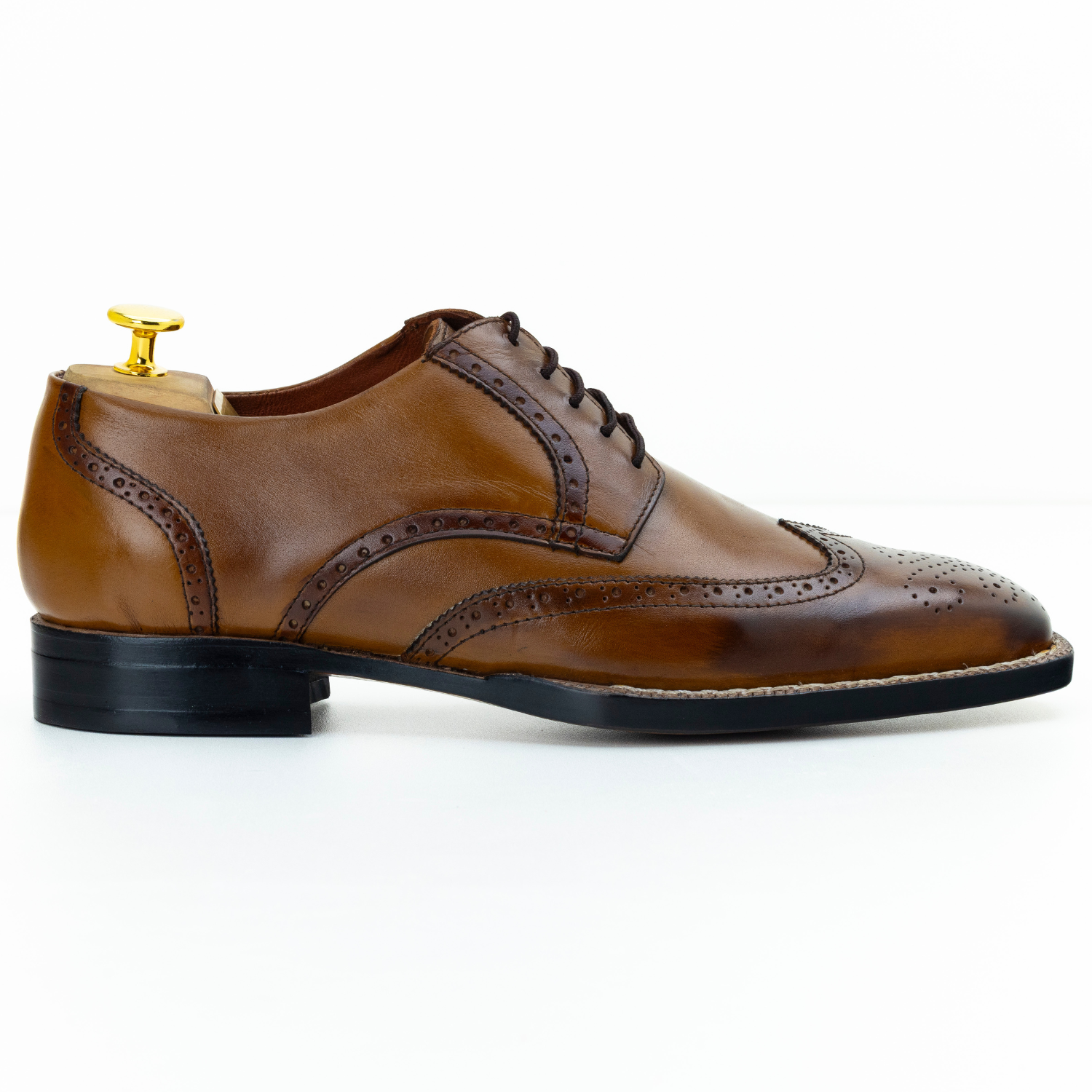 Brown leather dress shoe on a white background