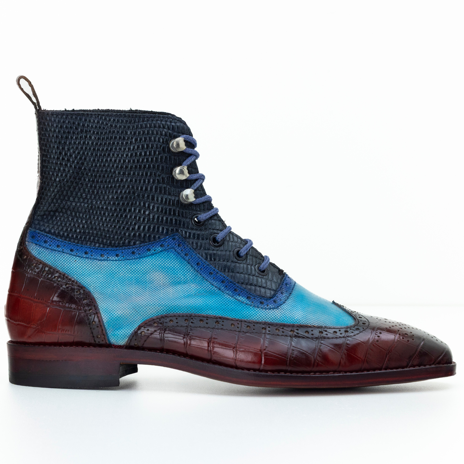Multicolored shoe with blue, brown, and black sections on a white background