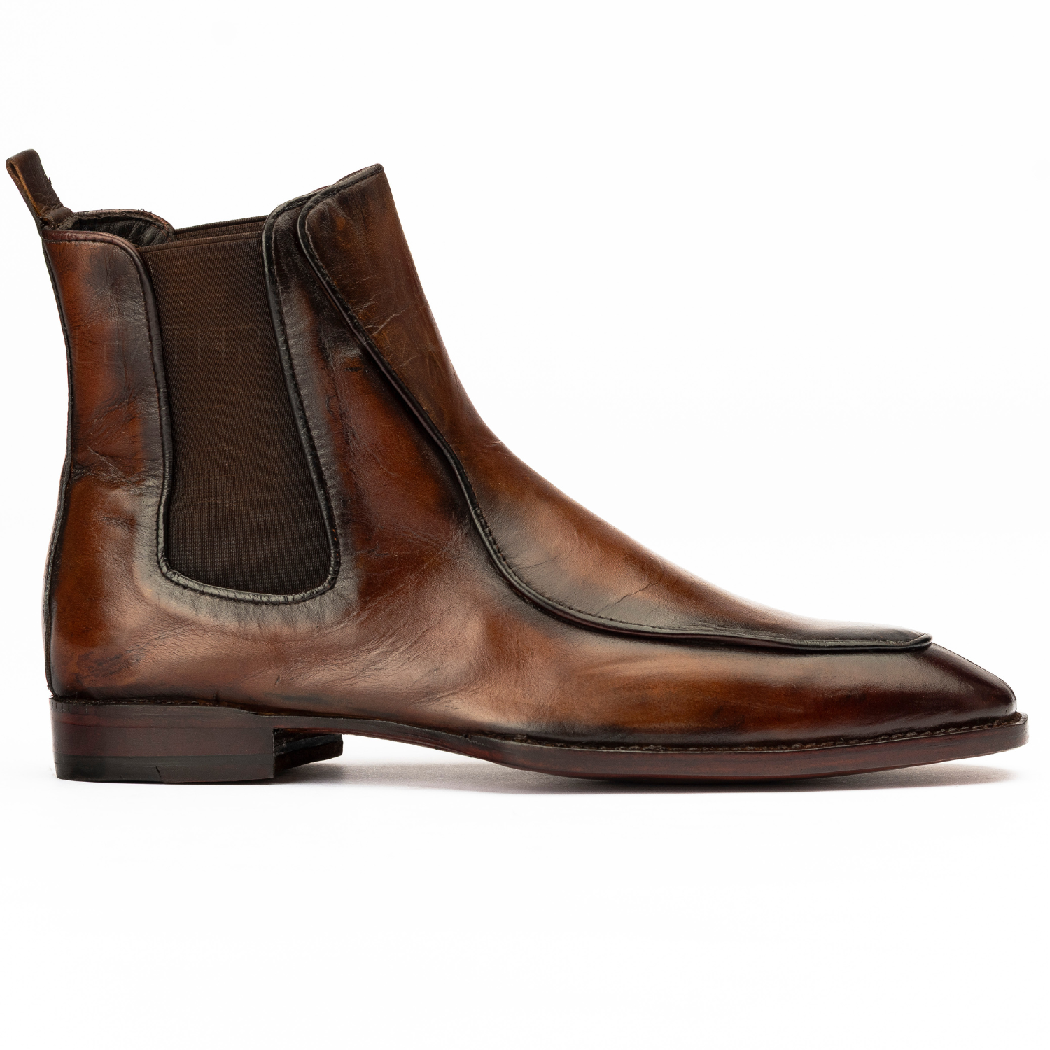Brown leather Chelsea boot on a white background