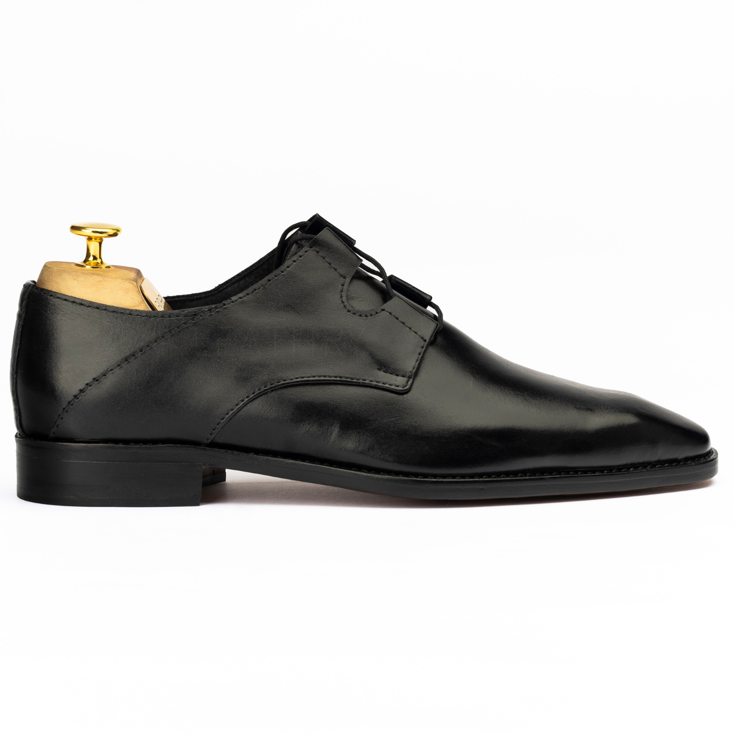 Black leather dress shoe on a white background