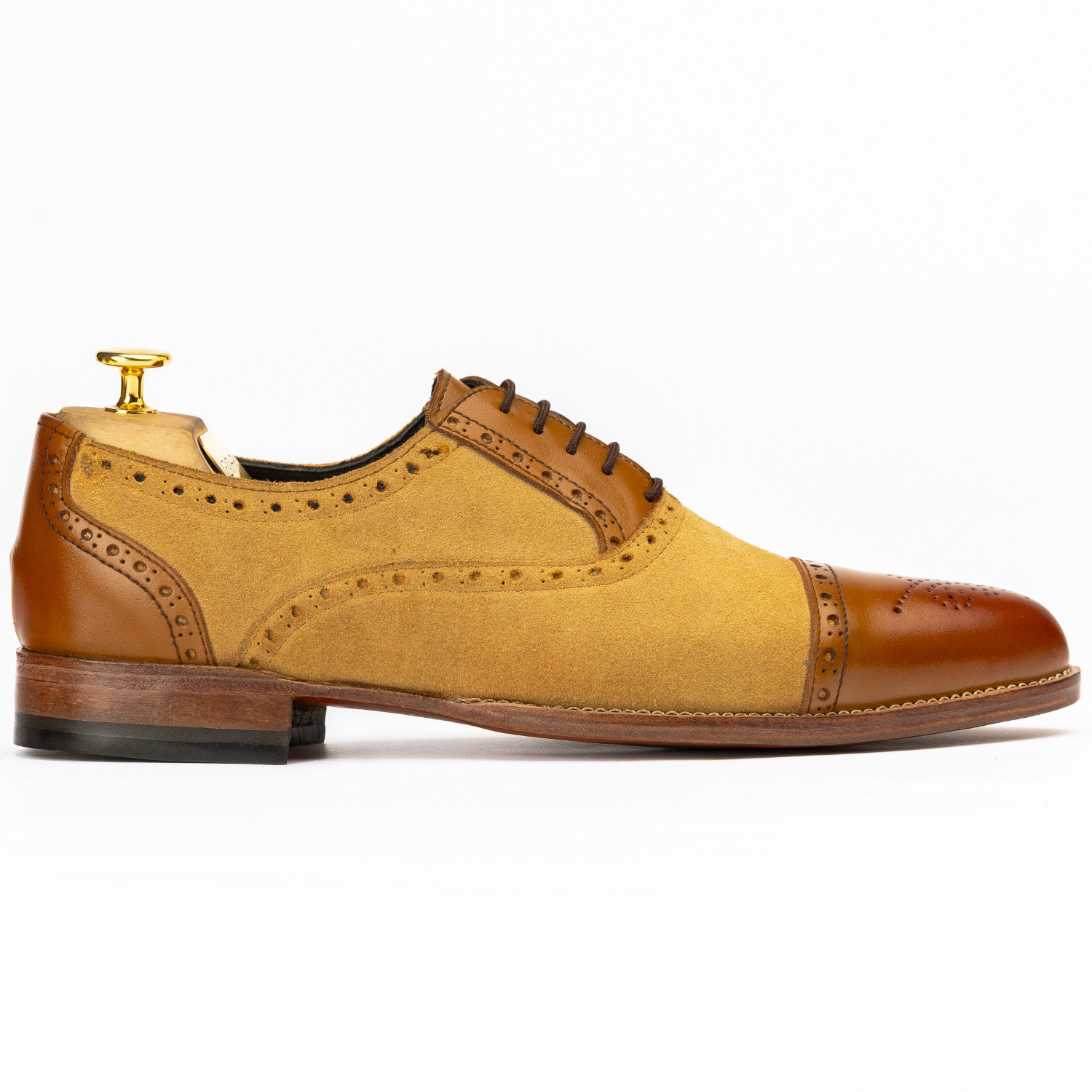 Brown and yellow dress shoe on a white background