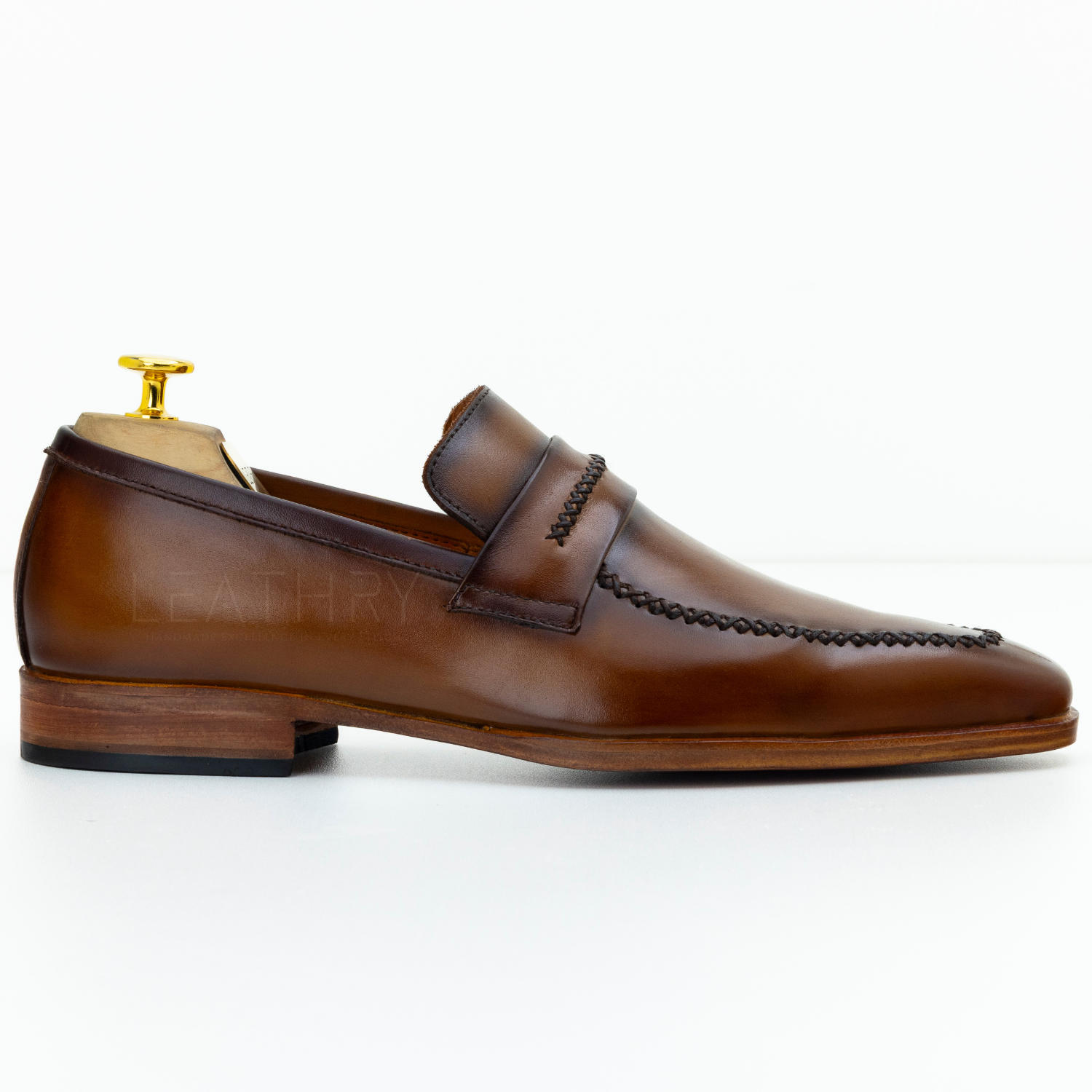 Brown leather loafer shoe on a white background