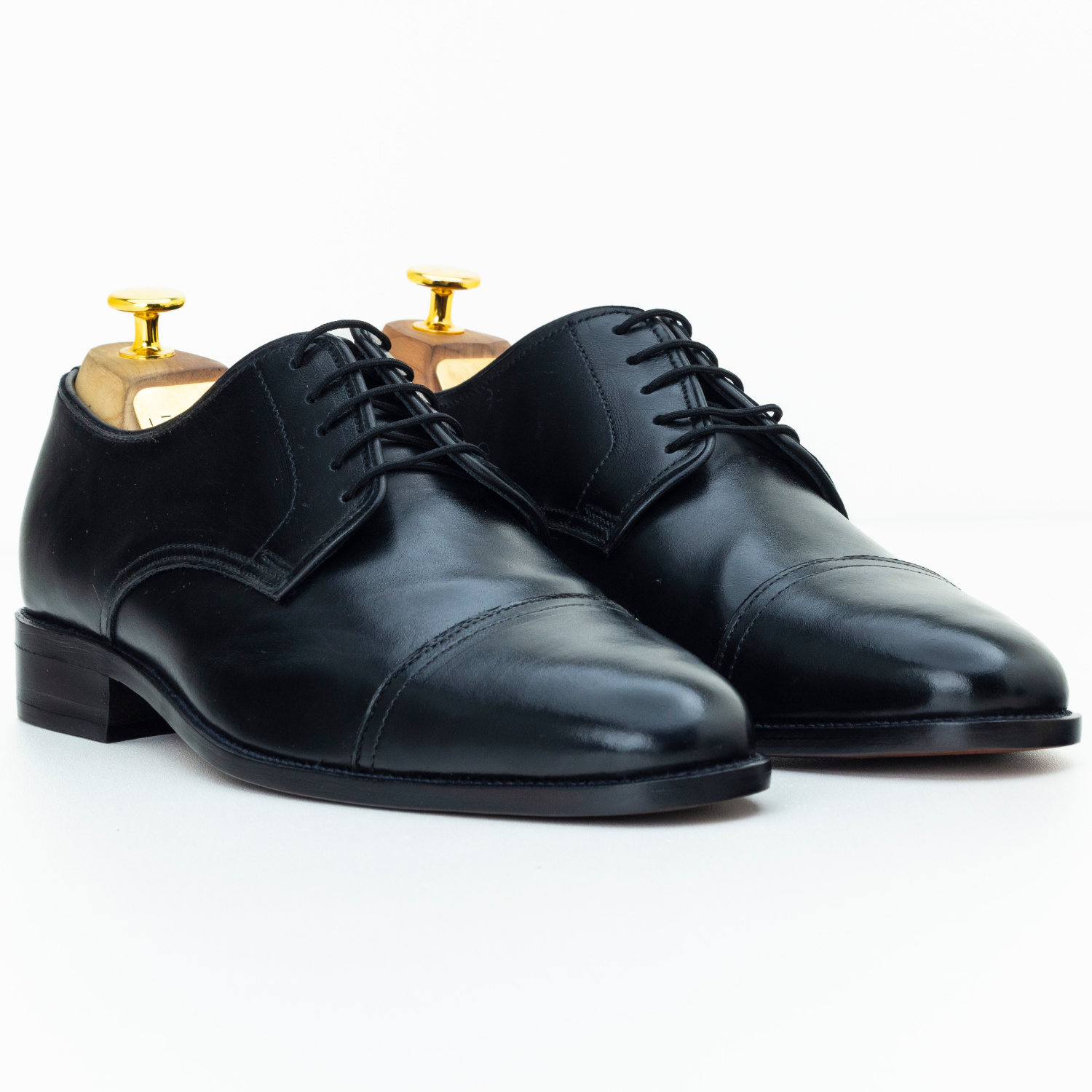 Pair of black dress shoes on a white background