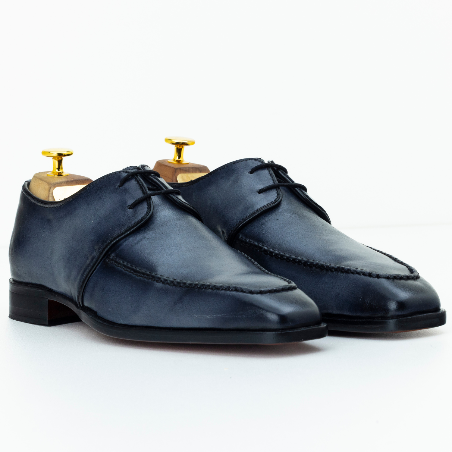 Pair of navy blue leather shoes on a white background