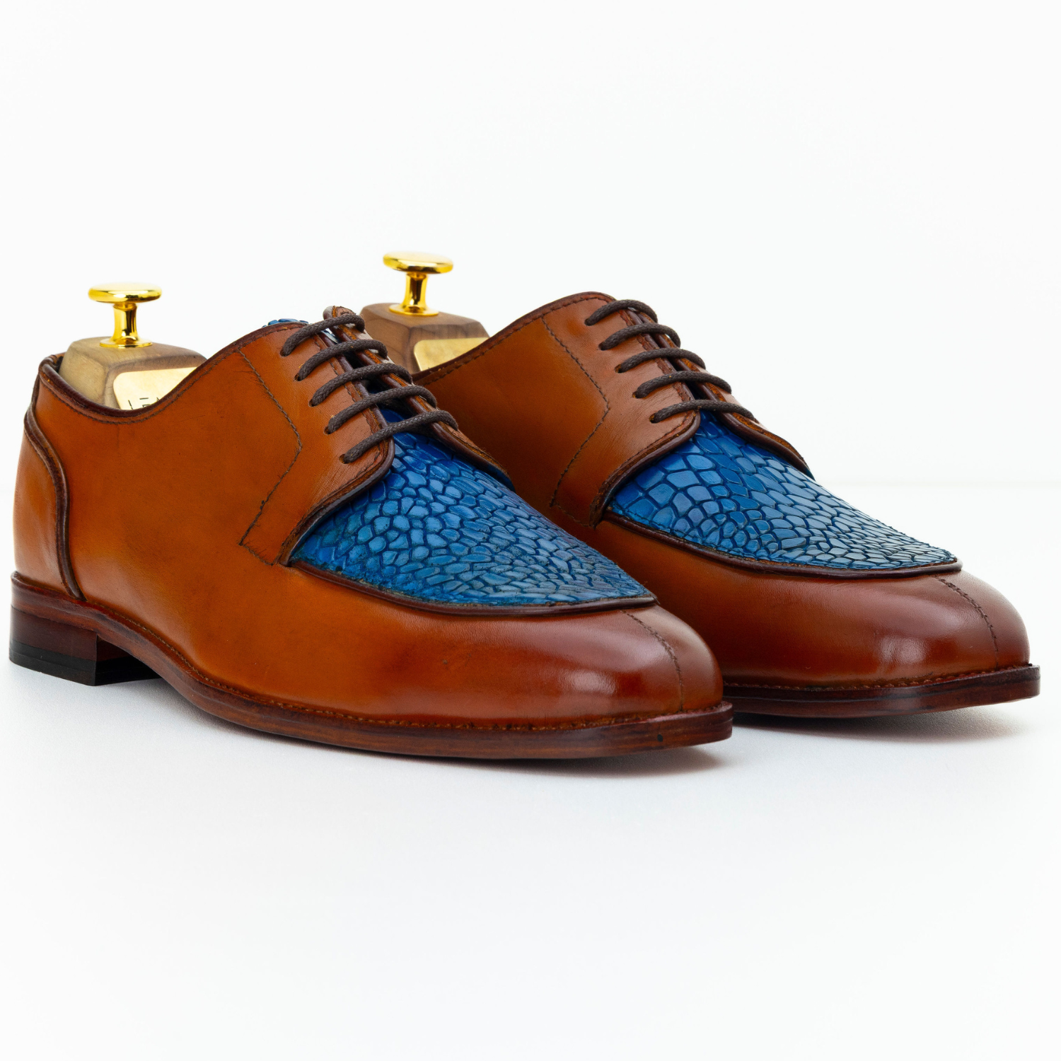 Brown leather shoes with blue insole on a white background