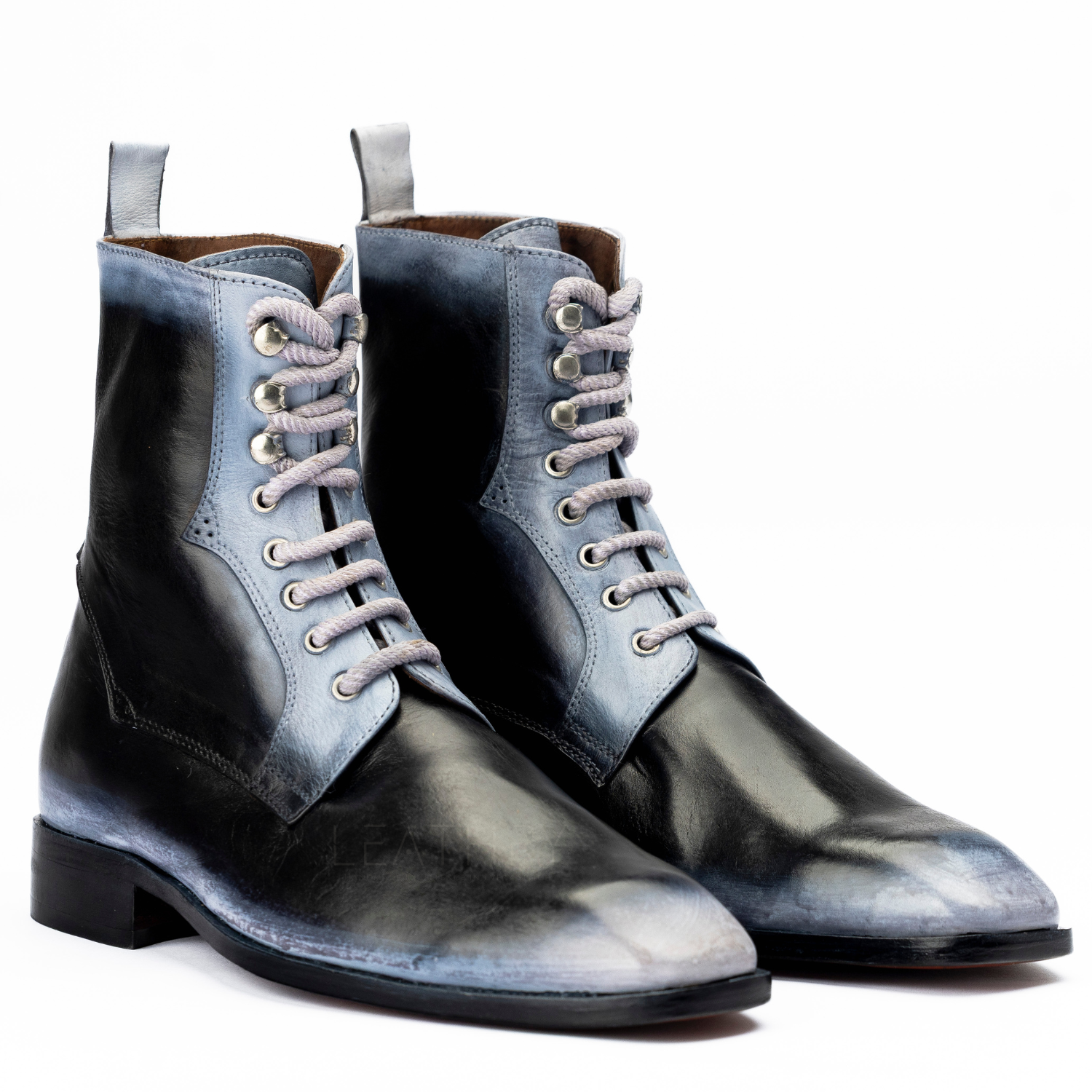 Pair of black and blue gradient boots on a white background