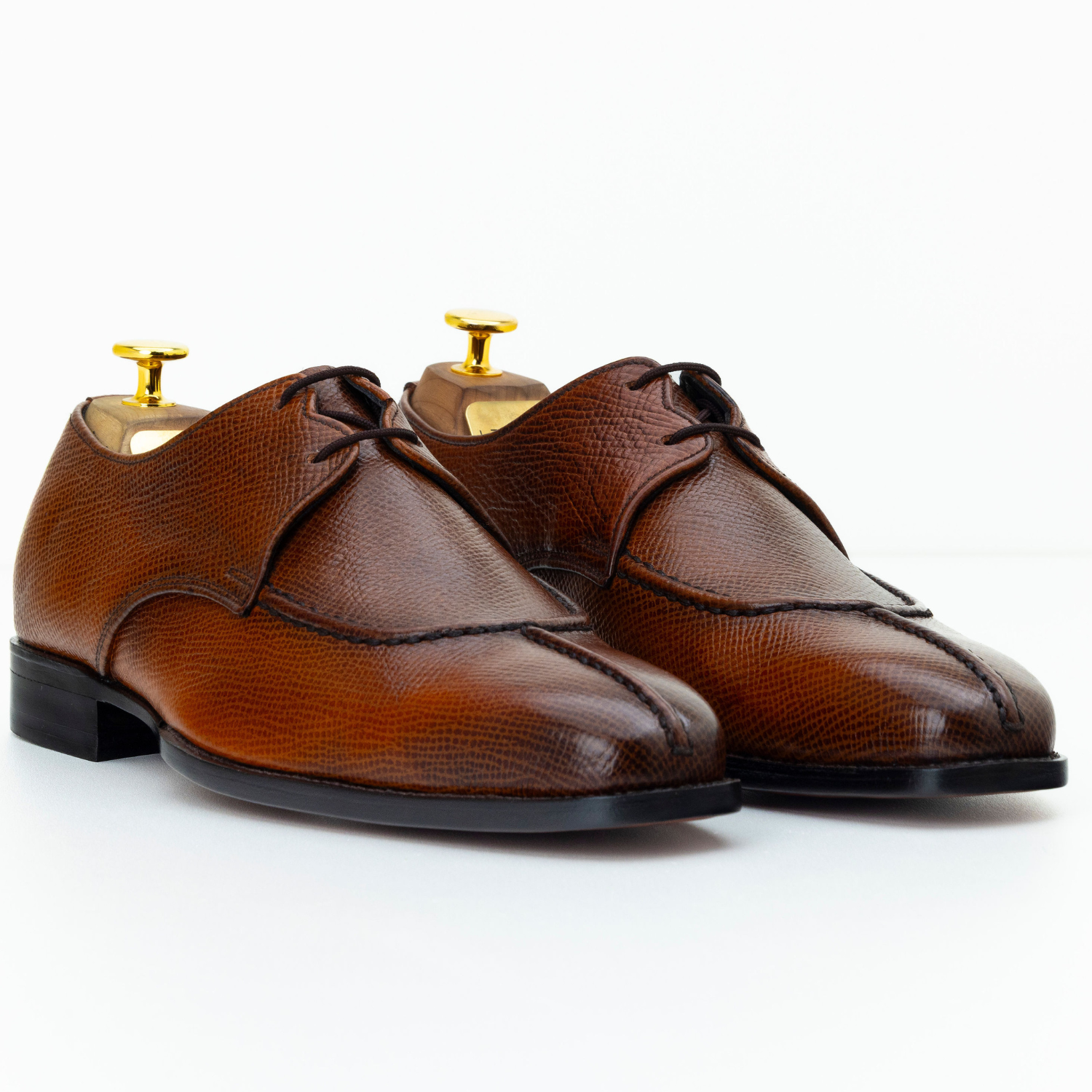 Pair of brown dress shoes on a white background