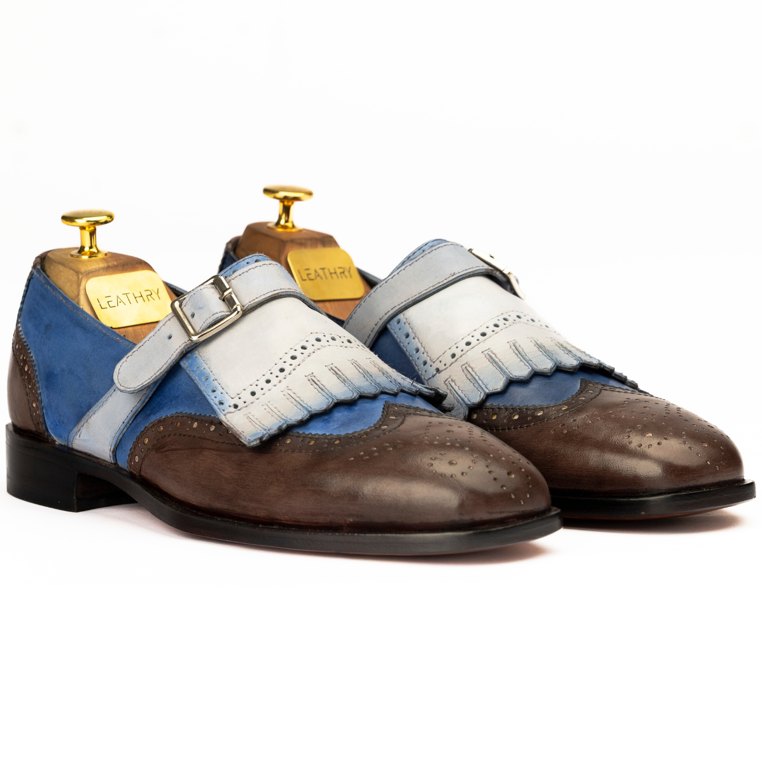 Pair of brown and blue shoes with white accents on a white background