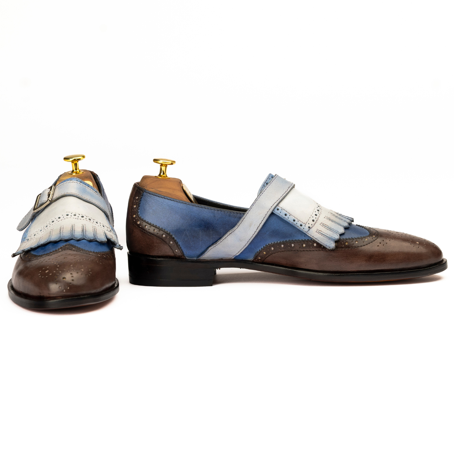 Pair of brown and blue shoes with white accents on a white background