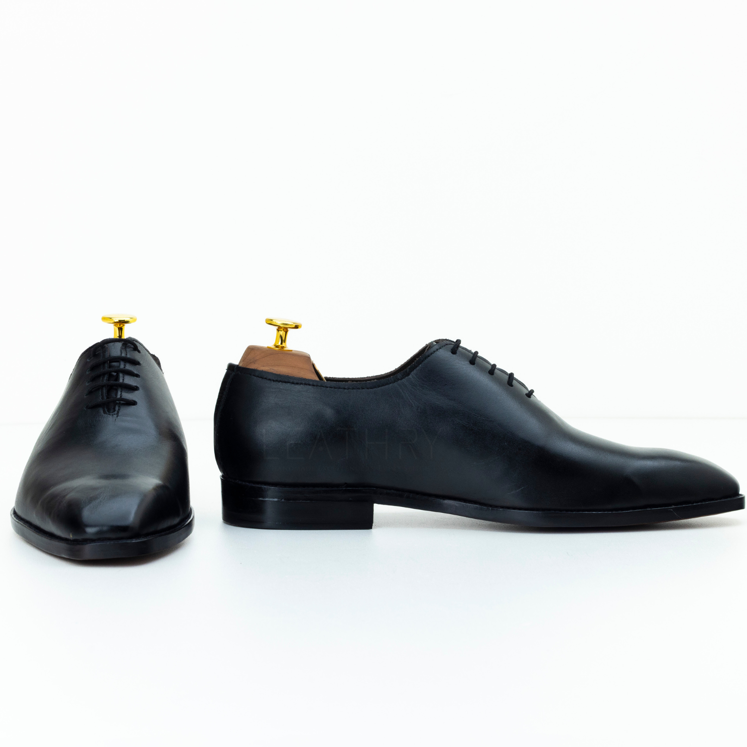 Pair of black dress shoes on a white background