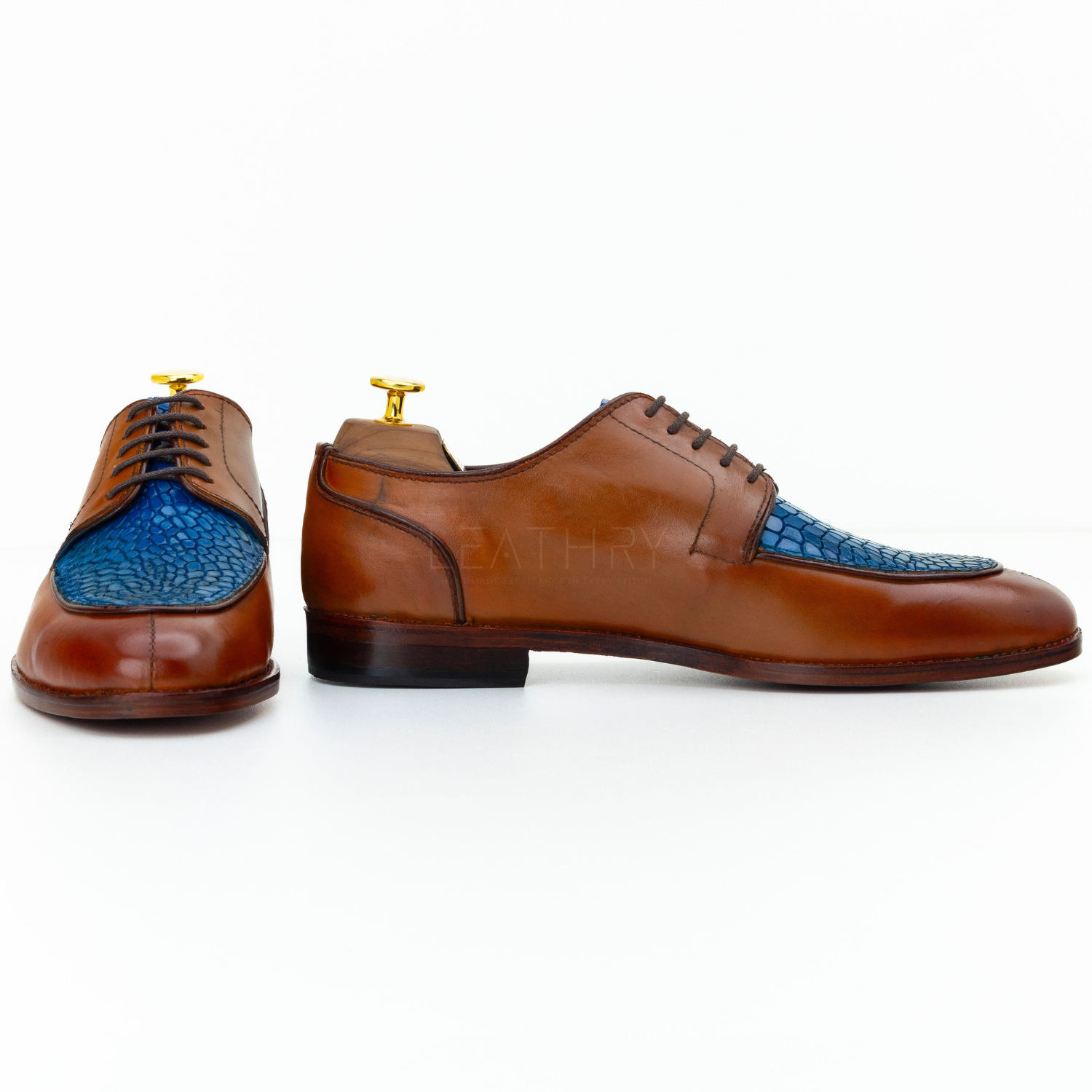 Brown leather dress shoes with blue insole on a white background