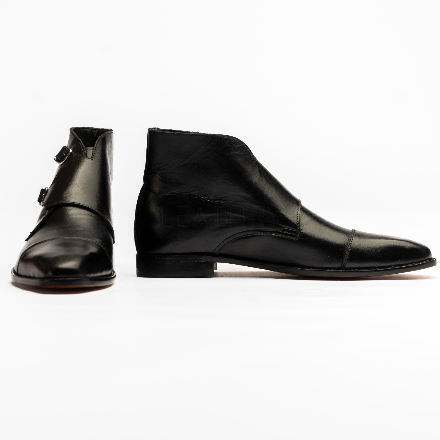 Pair of black leather boots on a white background