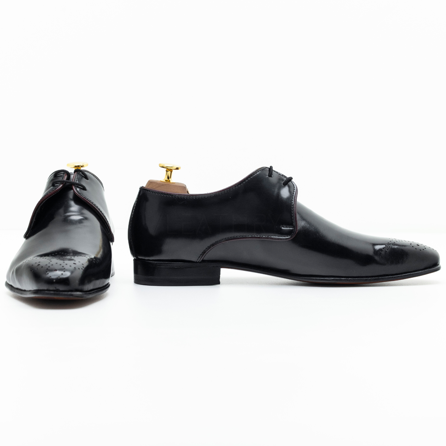 Pair of black dress shoes on a white background