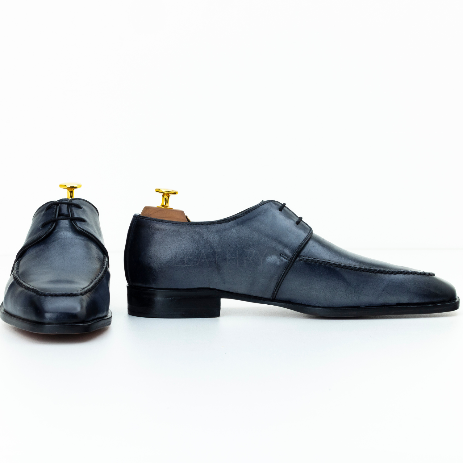 Pair of black leather shoes on a white background