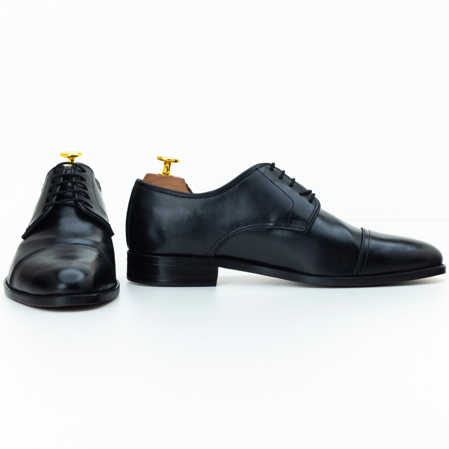 Pair of black dress shoes on a white background