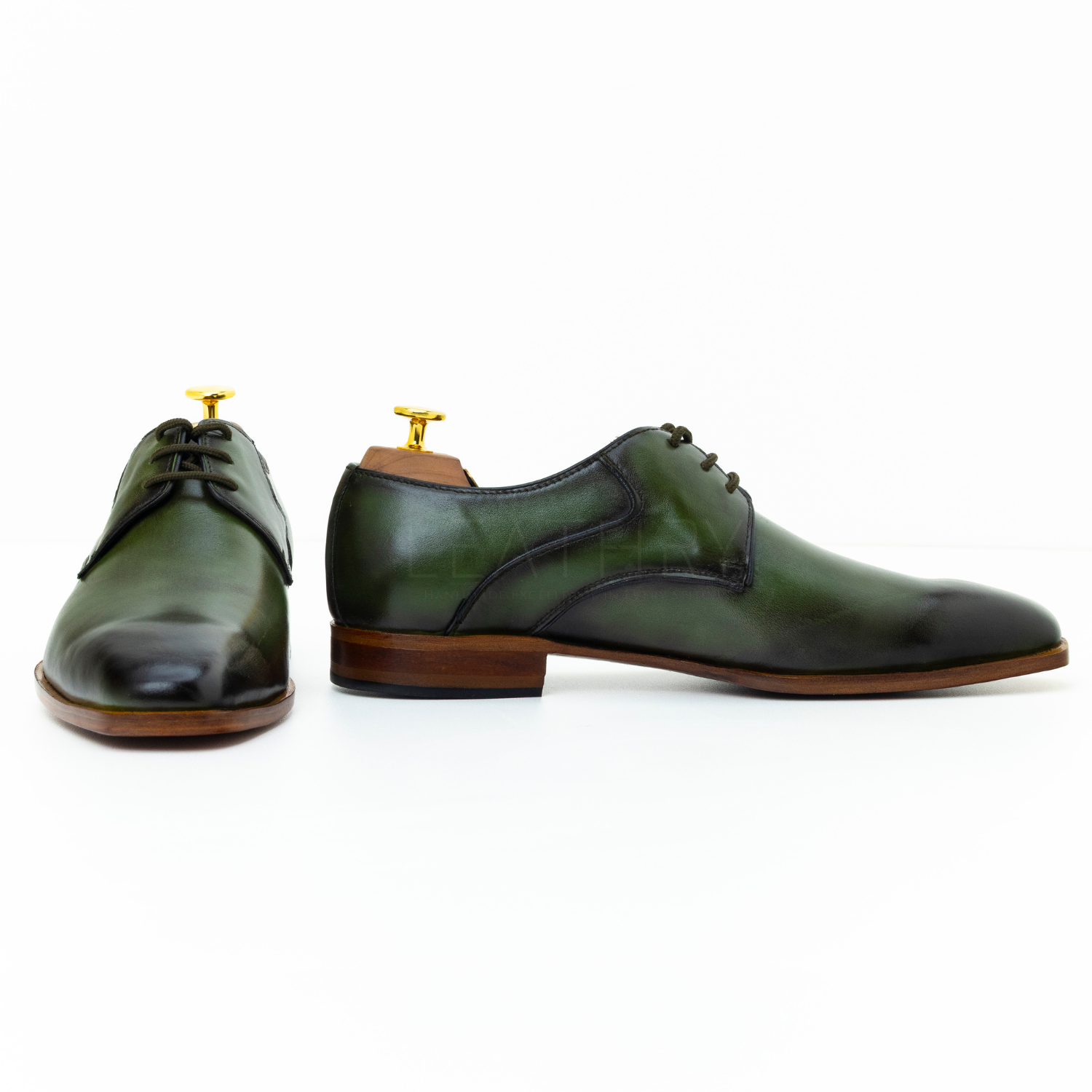 Pair of green leather shoes on a white background