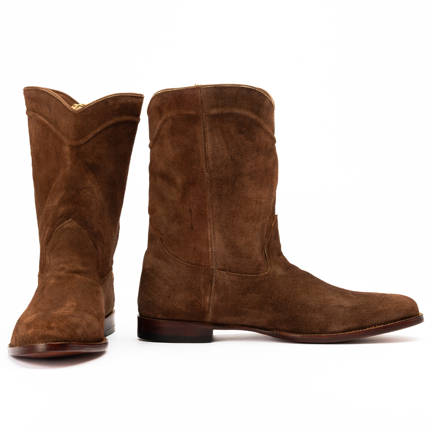 Pair of brown suede boots on a white background