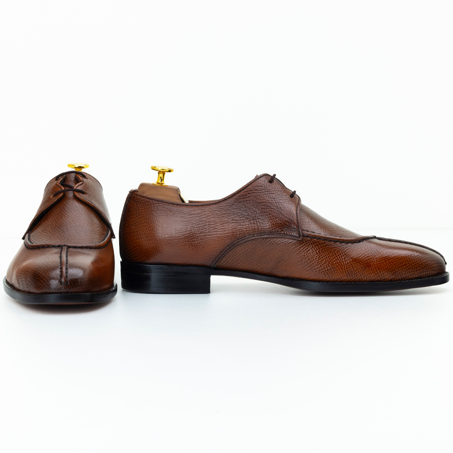 Brown leather dress shoes on a white background
