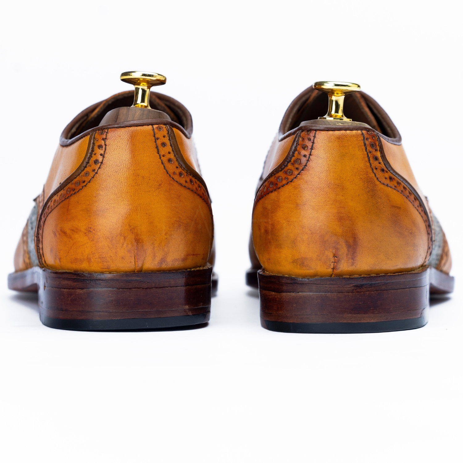 Brown leather dress shoes on a white background