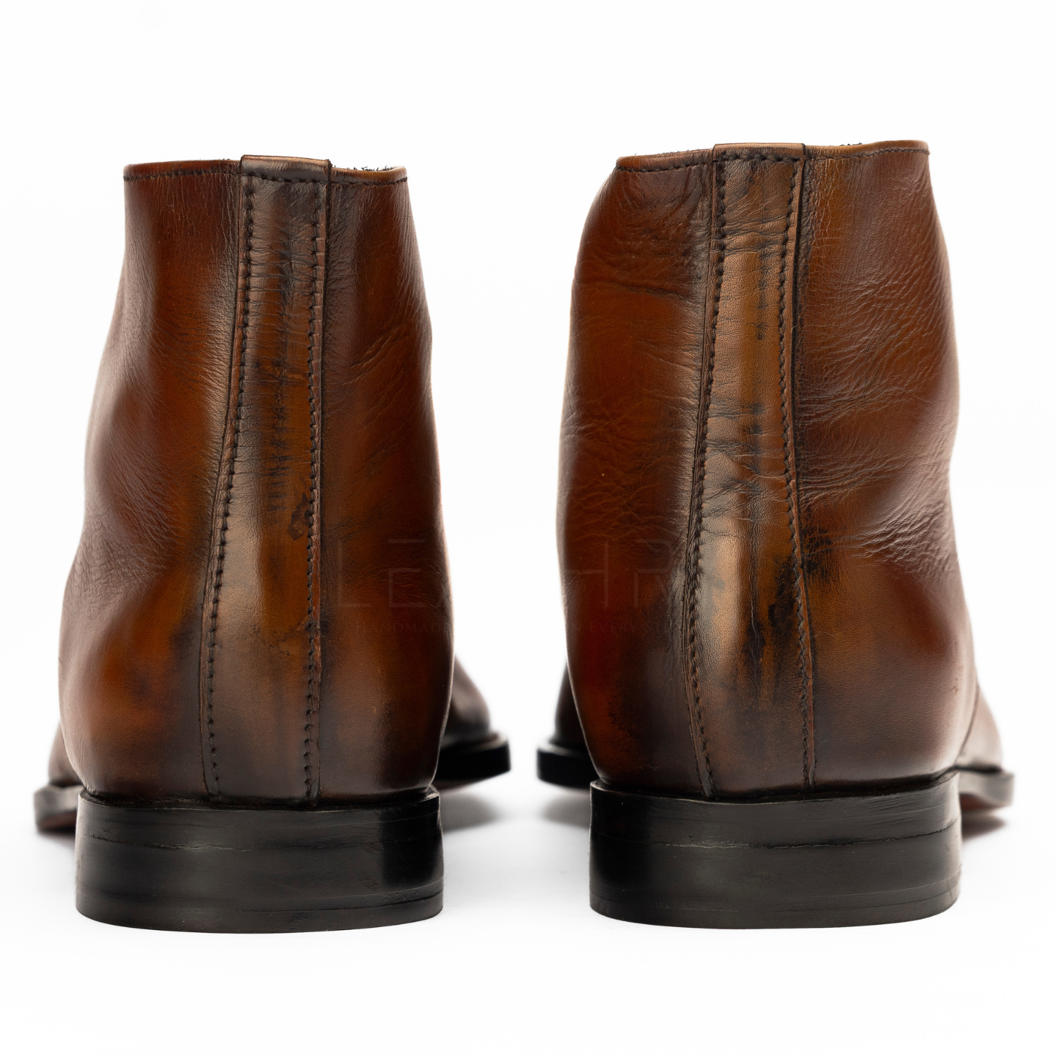 Pair of brown leather boots on a white background