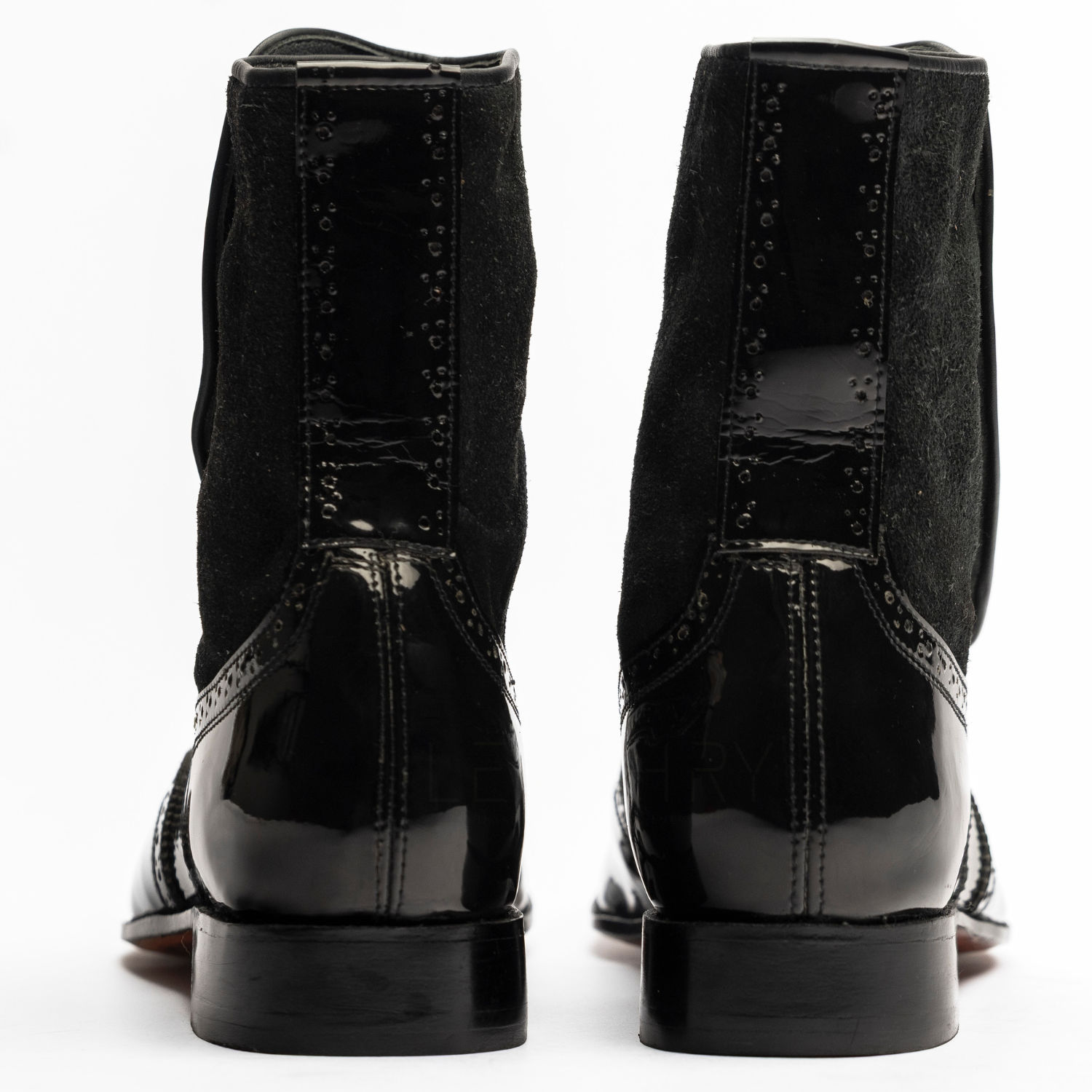Black dress shoes with glossy finish on a white background