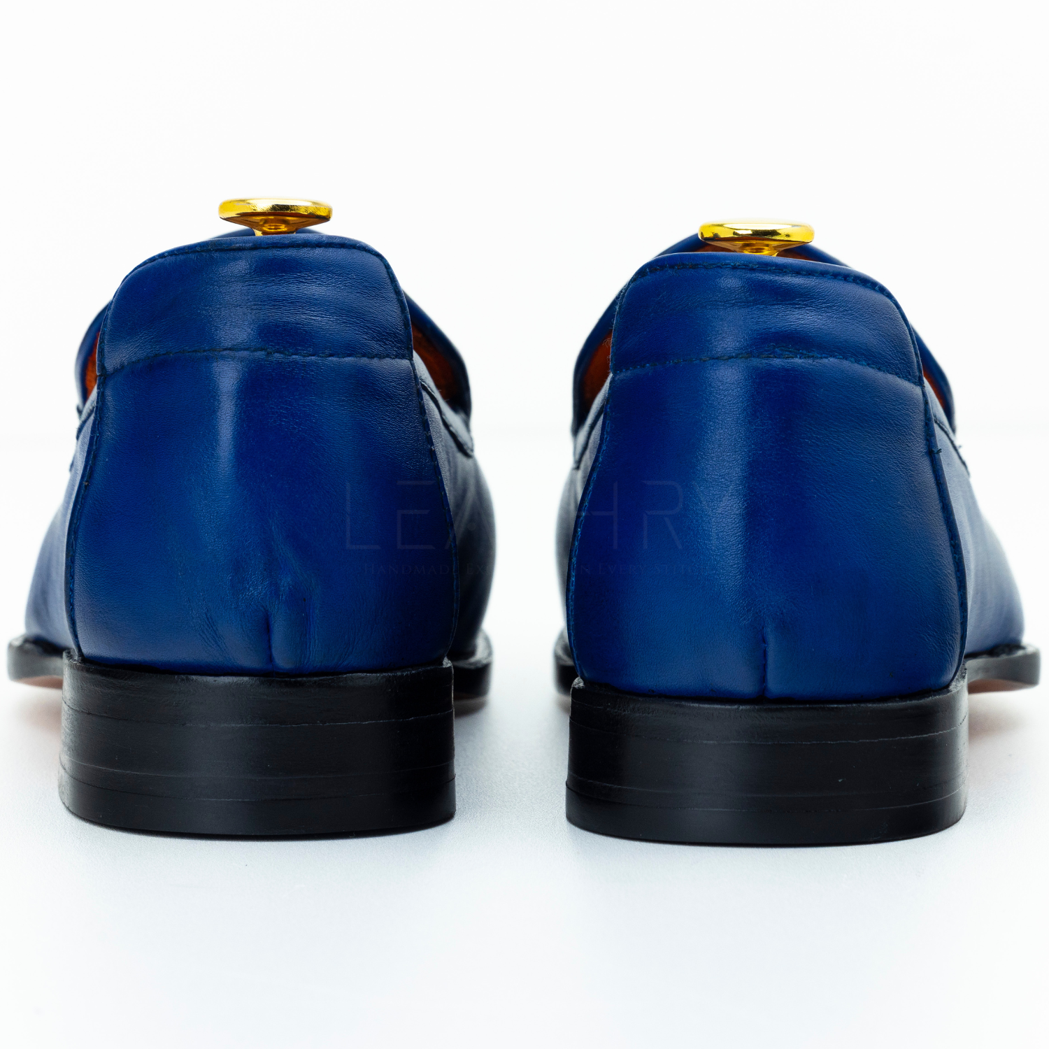 Pair of blue leather shoes on a white background
