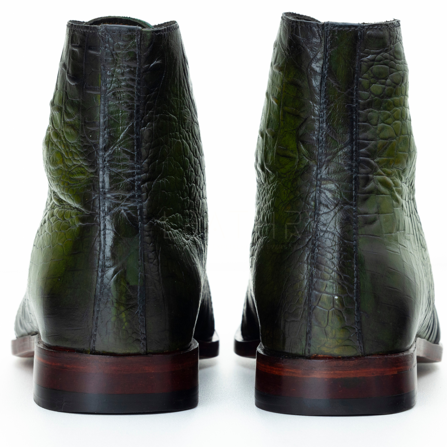 Green leather boots with a textured finish on a white background