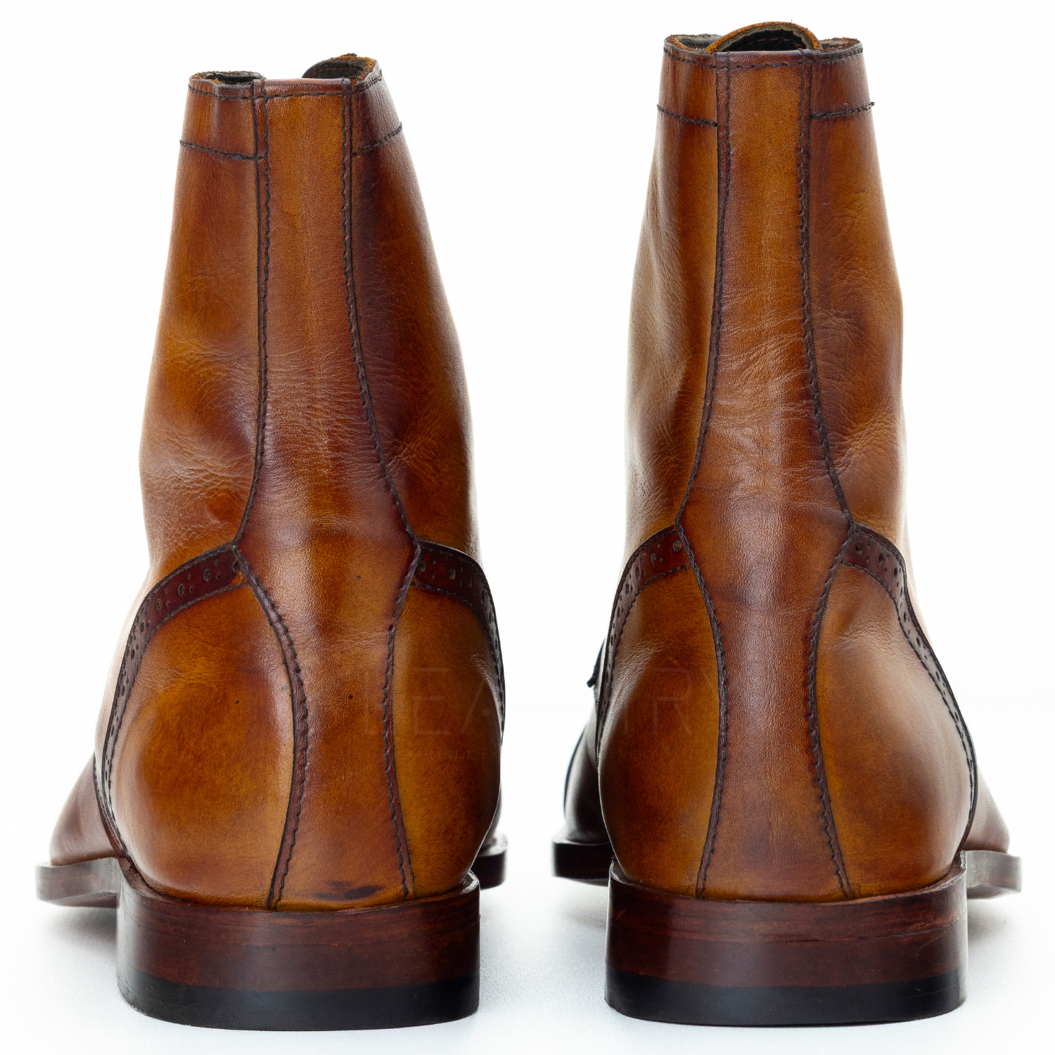 Pair of brown leather boots on a white background