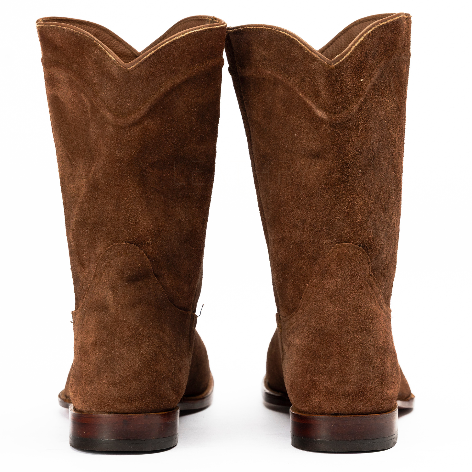 Pair of brown suede cowboy boots on a white background