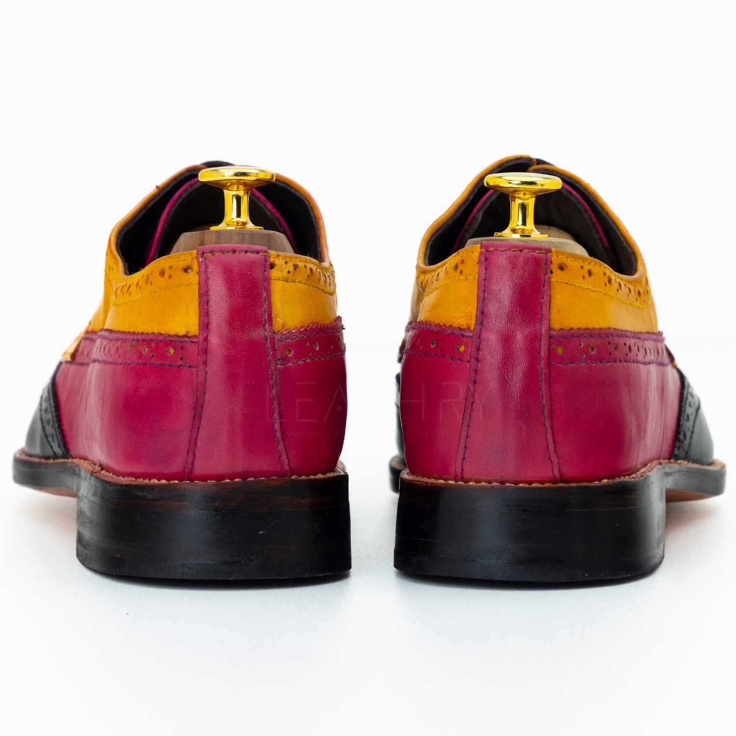 Pair of multicolored dress shoes on a white background