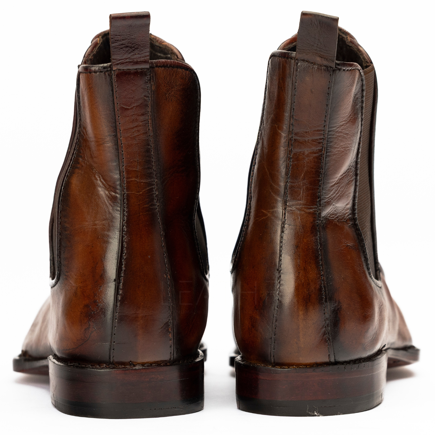 Pair of brown leather boots on a white background