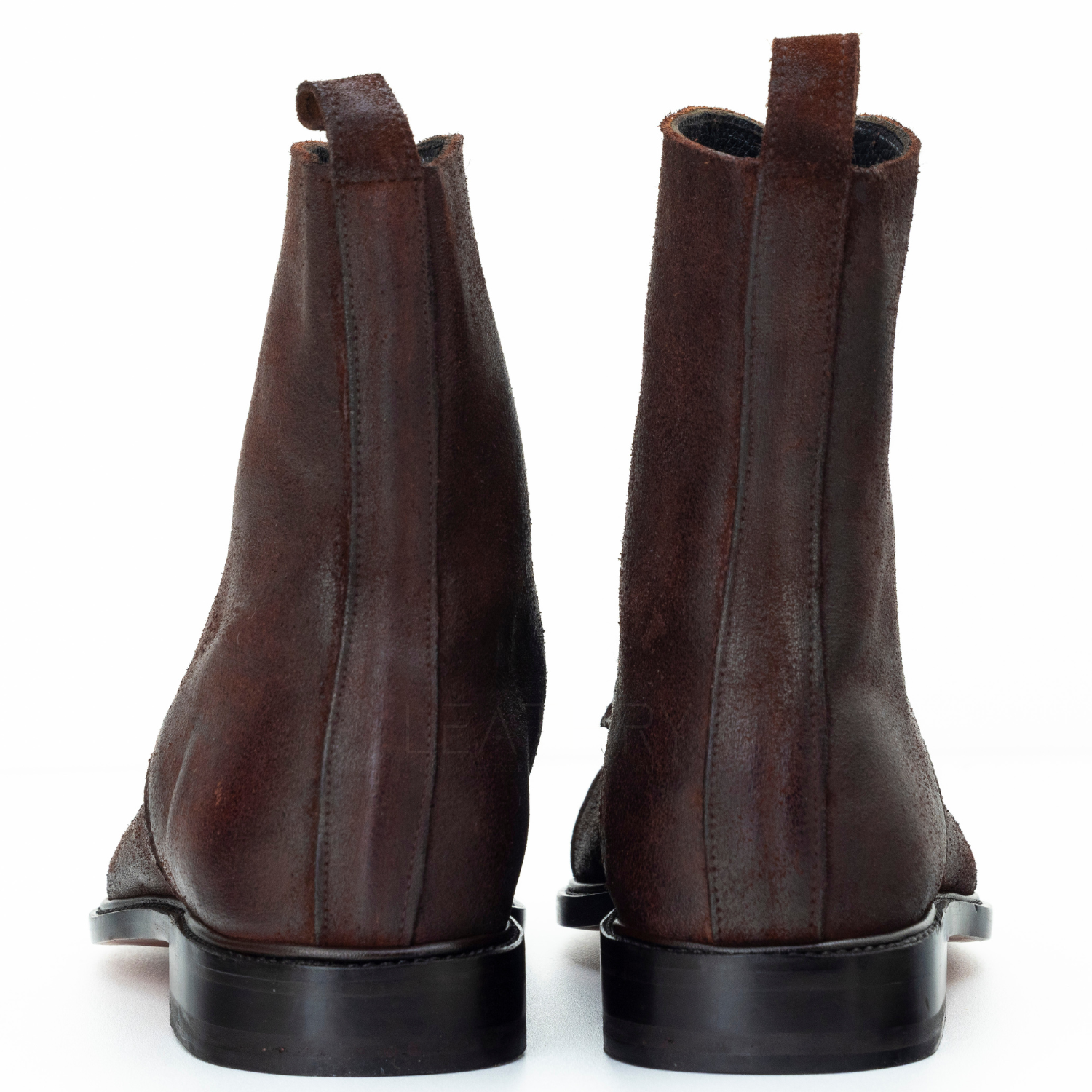 Pair of brown leather boots on a white background