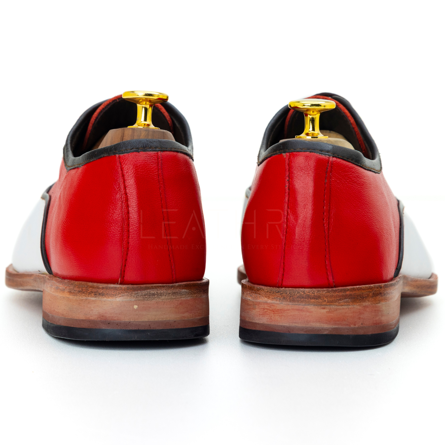Red and white shoes with gold accents on a white background
