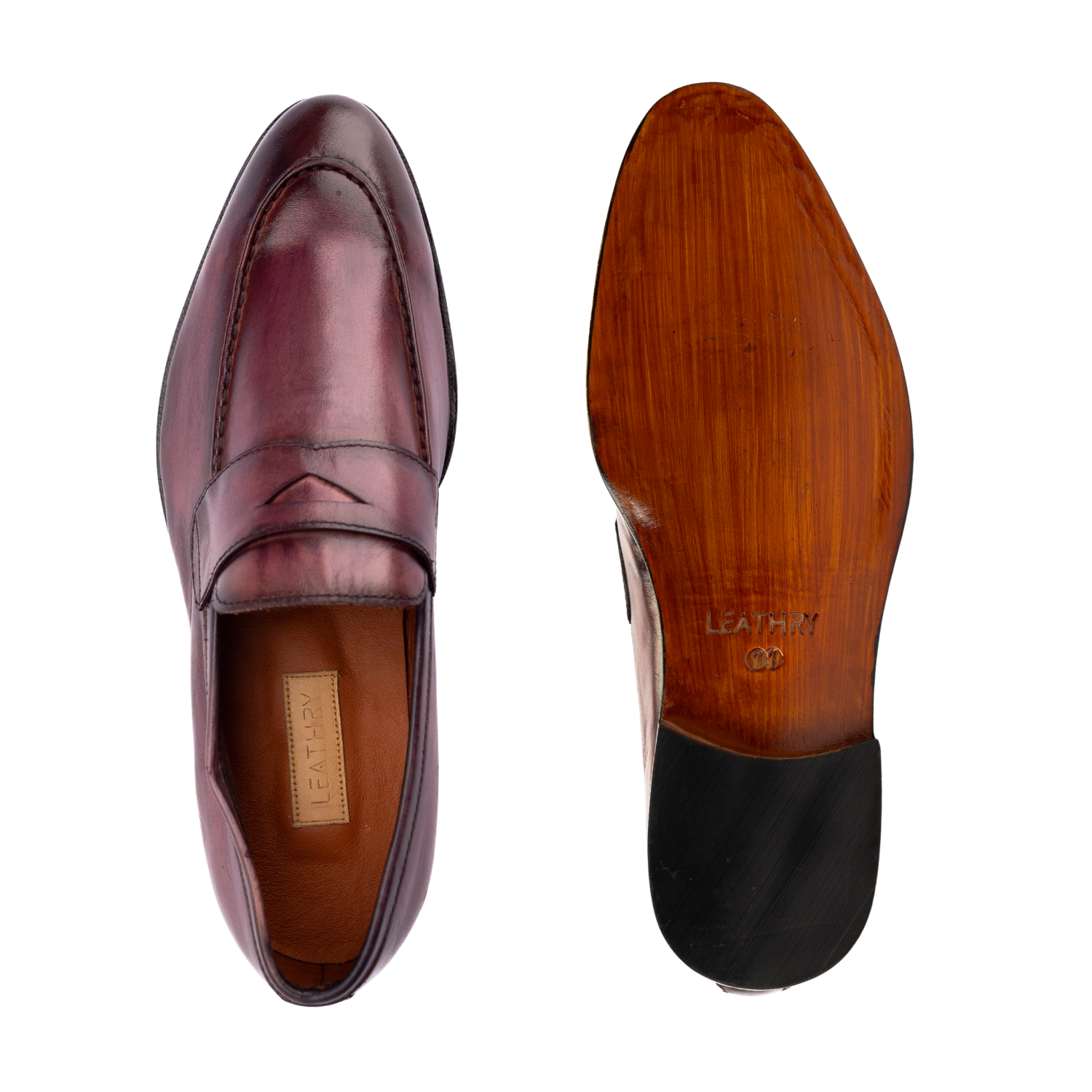 Pair of maroon leather shoes with wooden soles on a white background