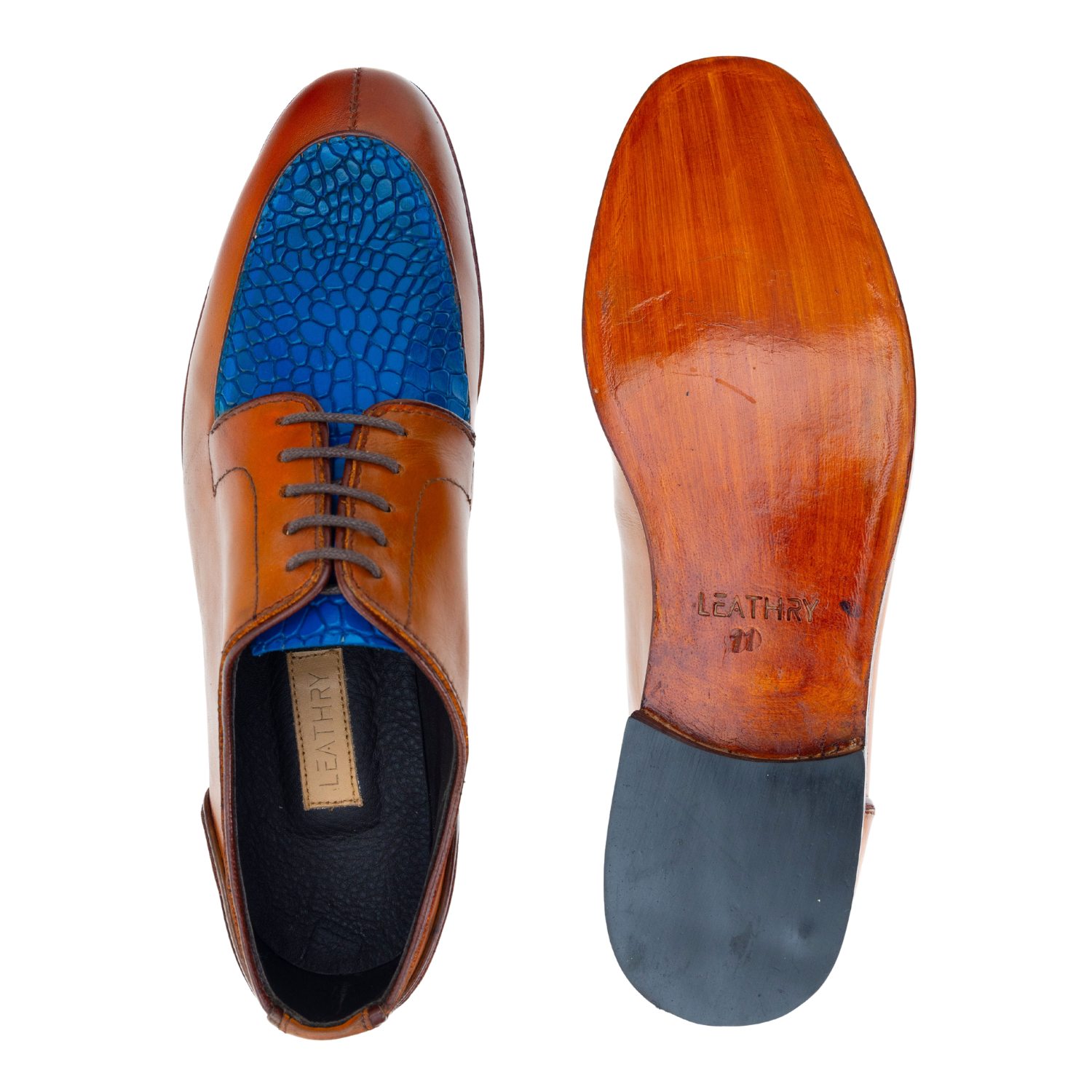 Brown leather dress shoes with blue interior and black sole on a white background