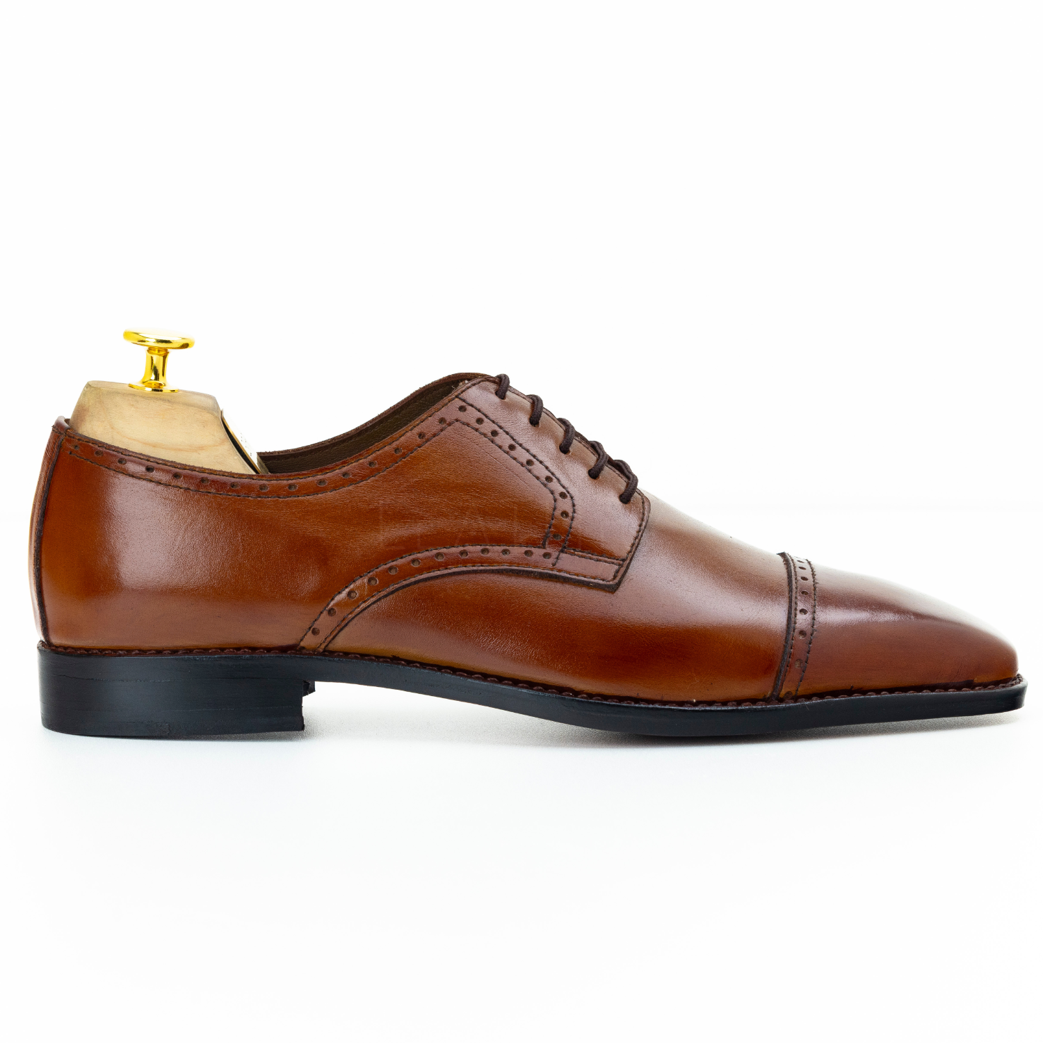 Brown leather dress shoe on a white background