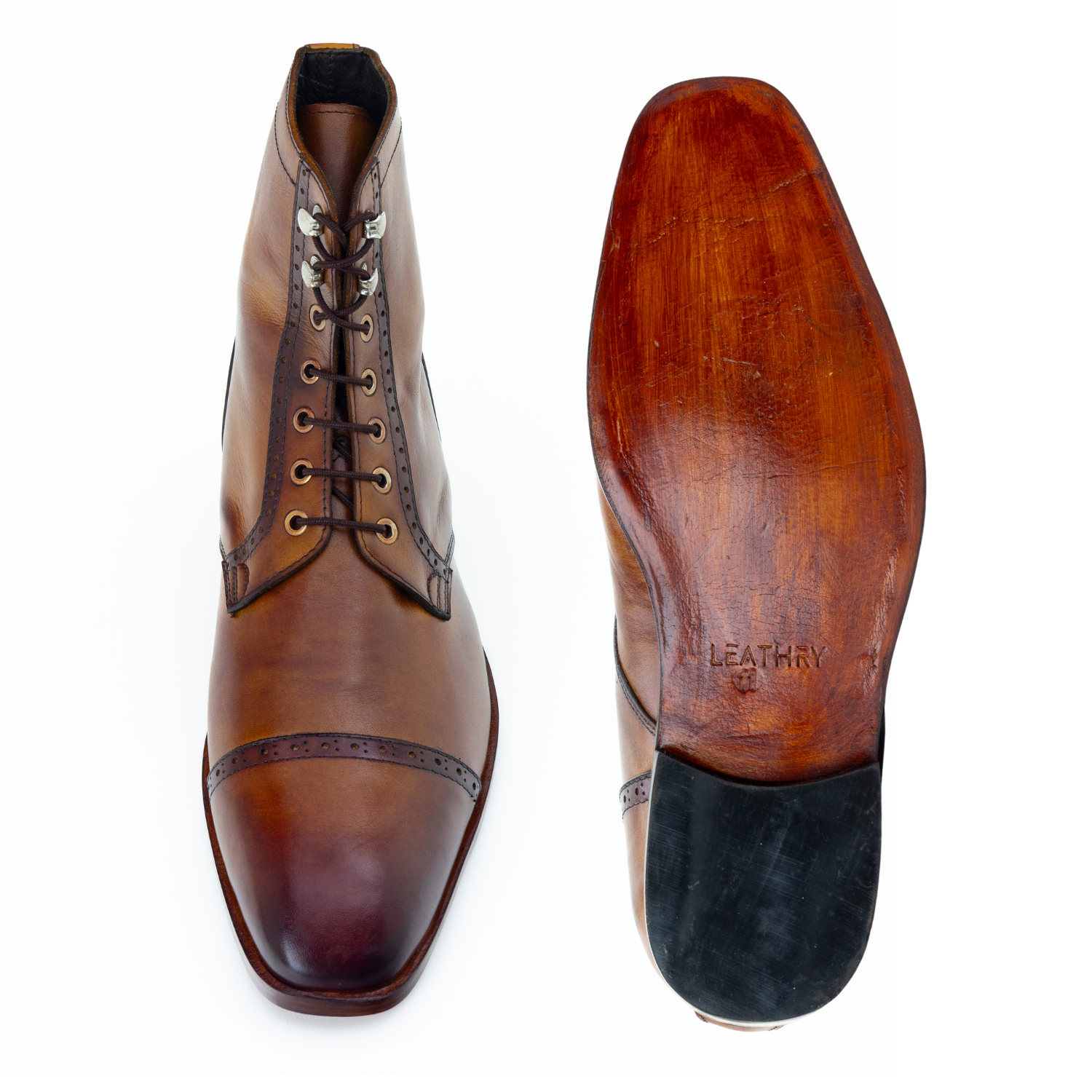 Brown leather dress shoes with a visible brand name on a white background