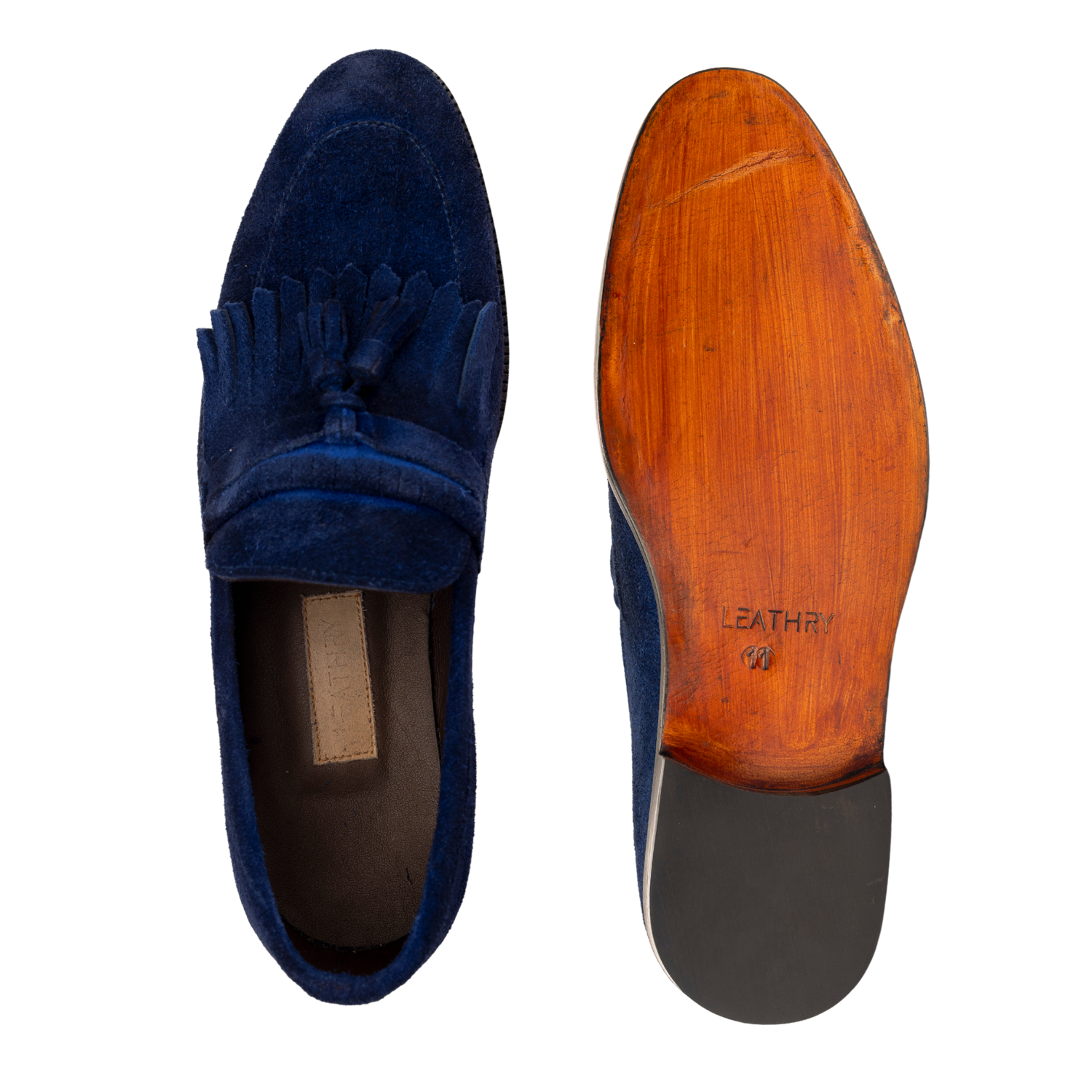 Blue suede loafer with tassel on a white background