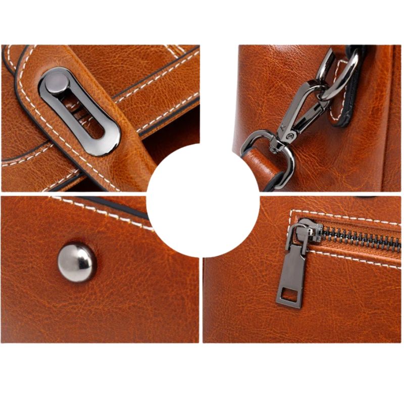 Close-up of brown leather bag with metal zipper and clasp